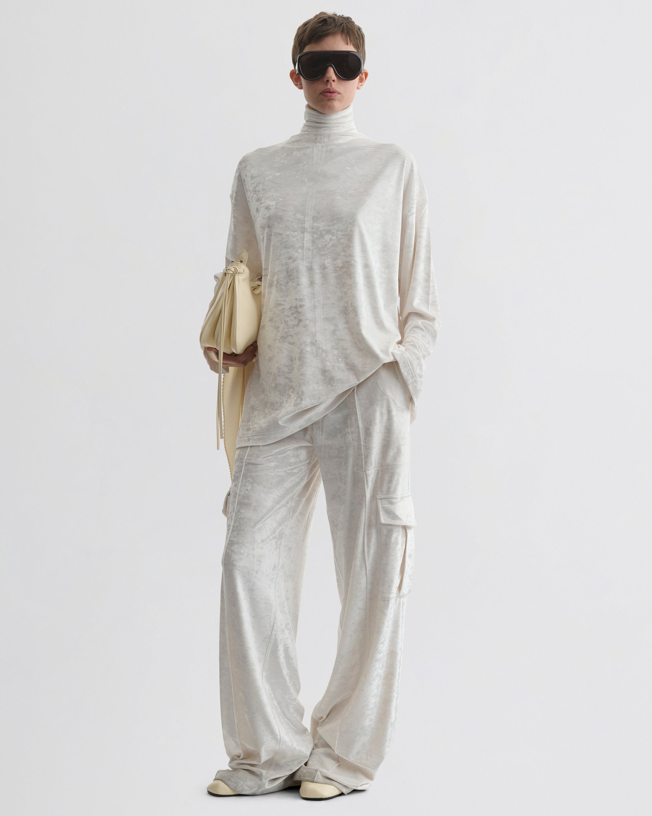 Front view of model wearing LIQUID CARGO TROUSERS  in white crushed velvet