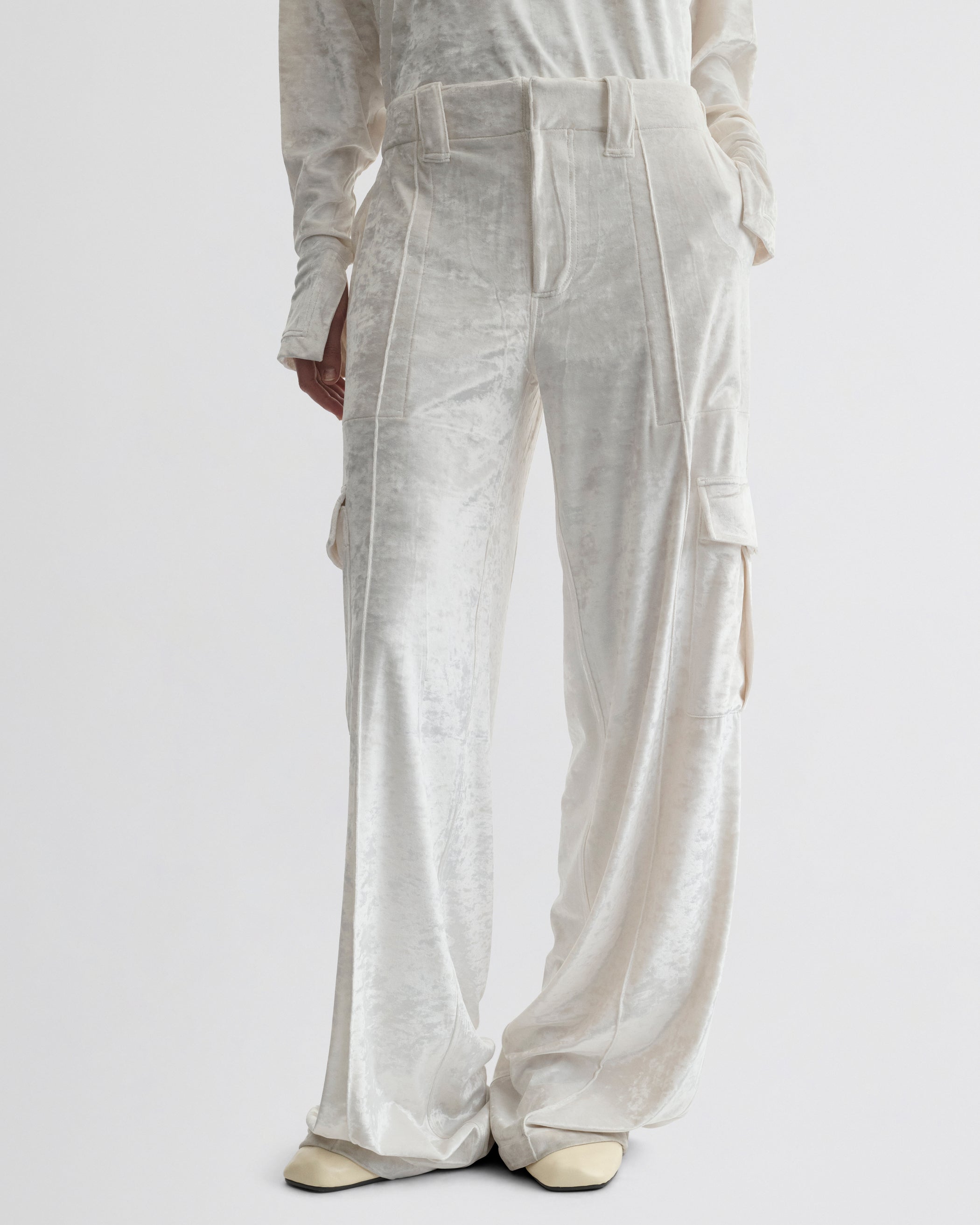 Front view of model wearing LIQUID CARGO TROUSERS  in white crushed velvet
