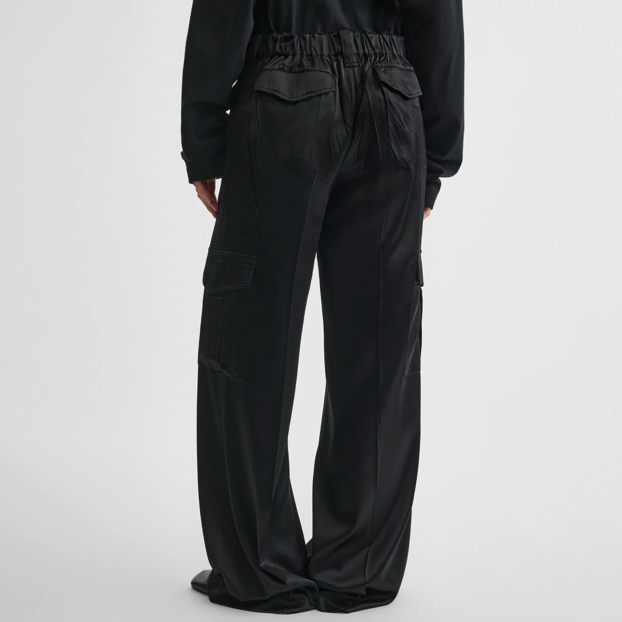 Back view of liquid cargo trousers in black silk
