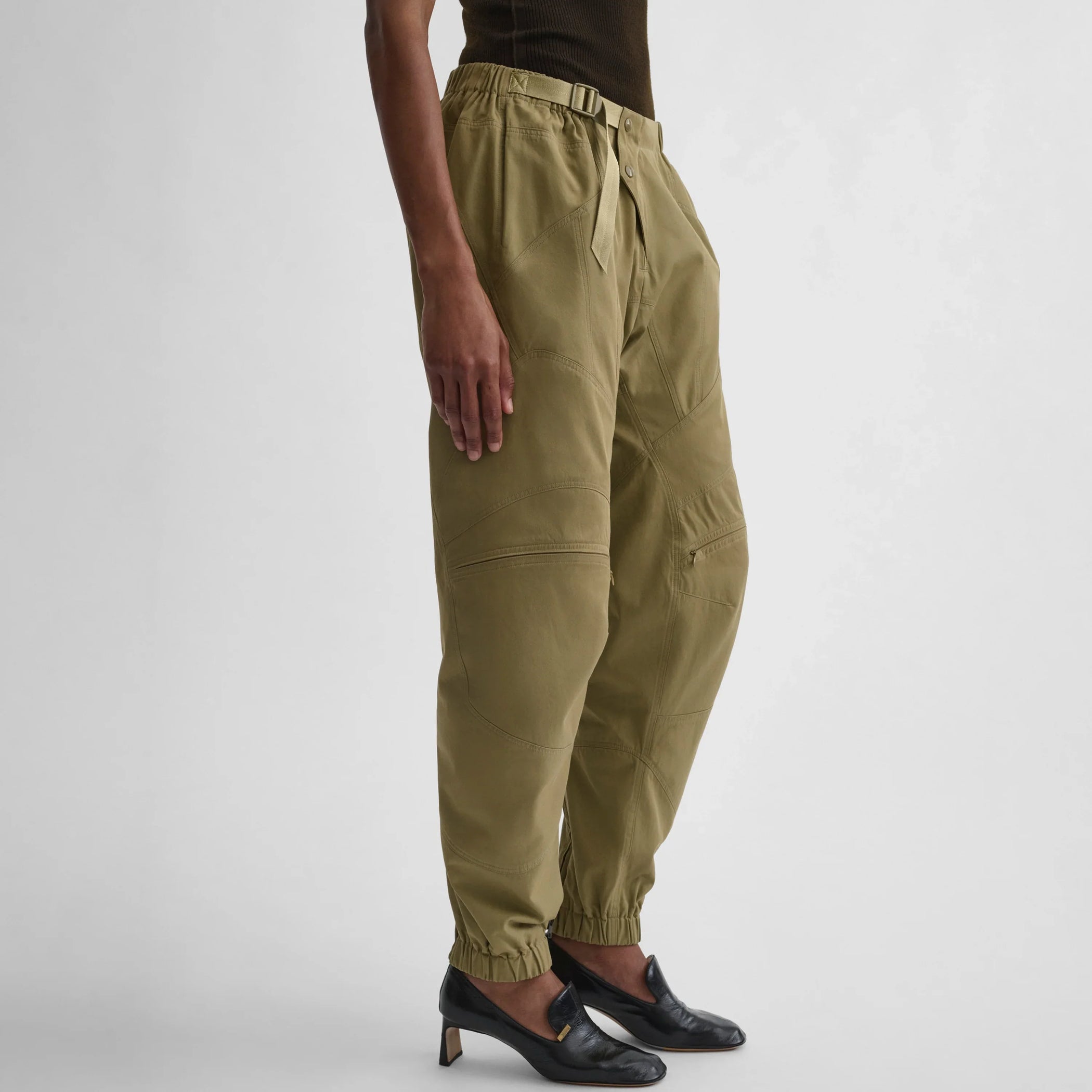 Angled view of the model wearing the BMX trousers in sage