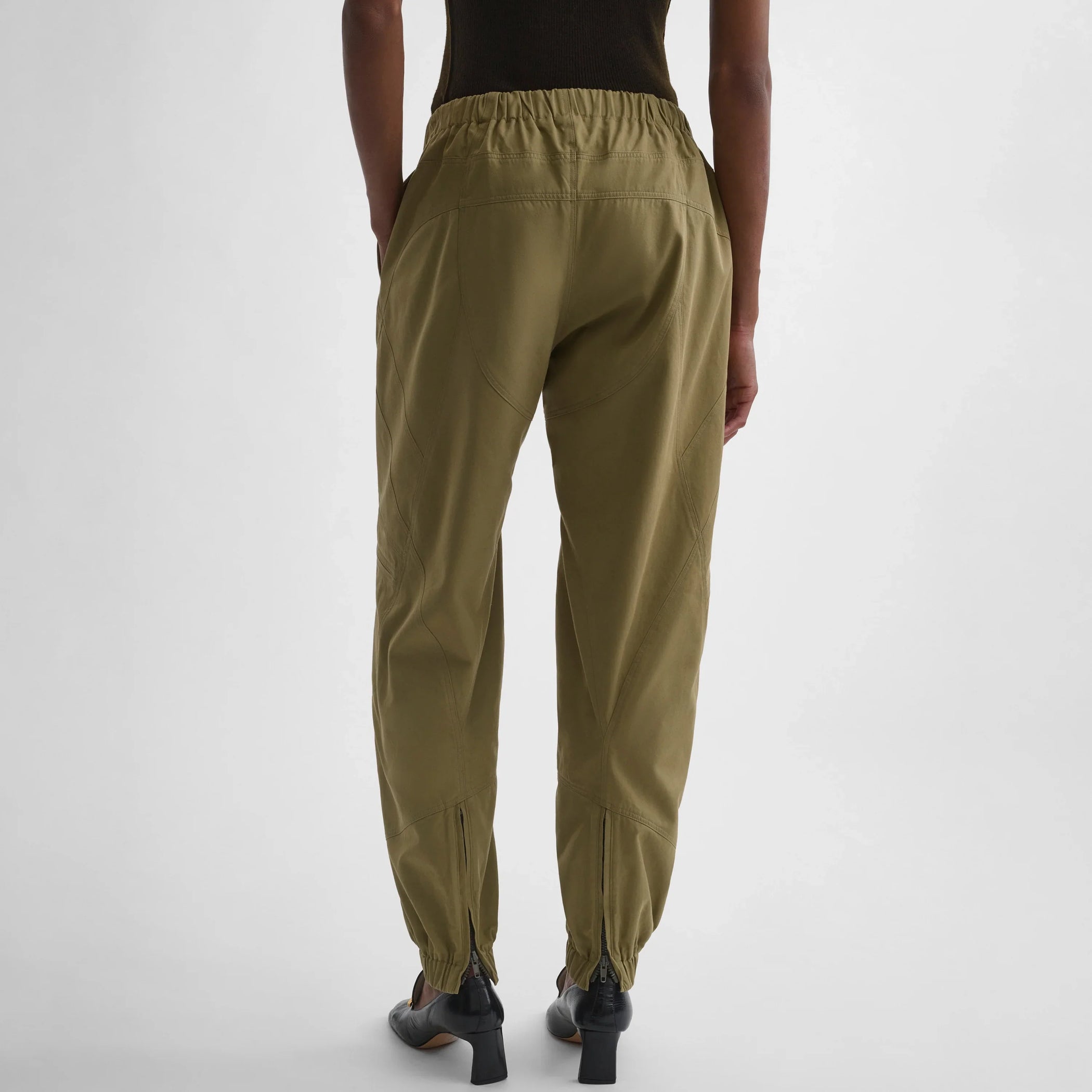 Back view of the model wearing the BMX trousers in sage