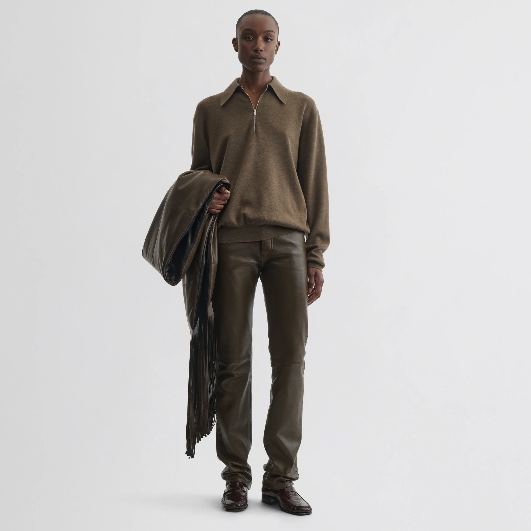 Front view of model wearing straight leg jeans in green bronze leather.