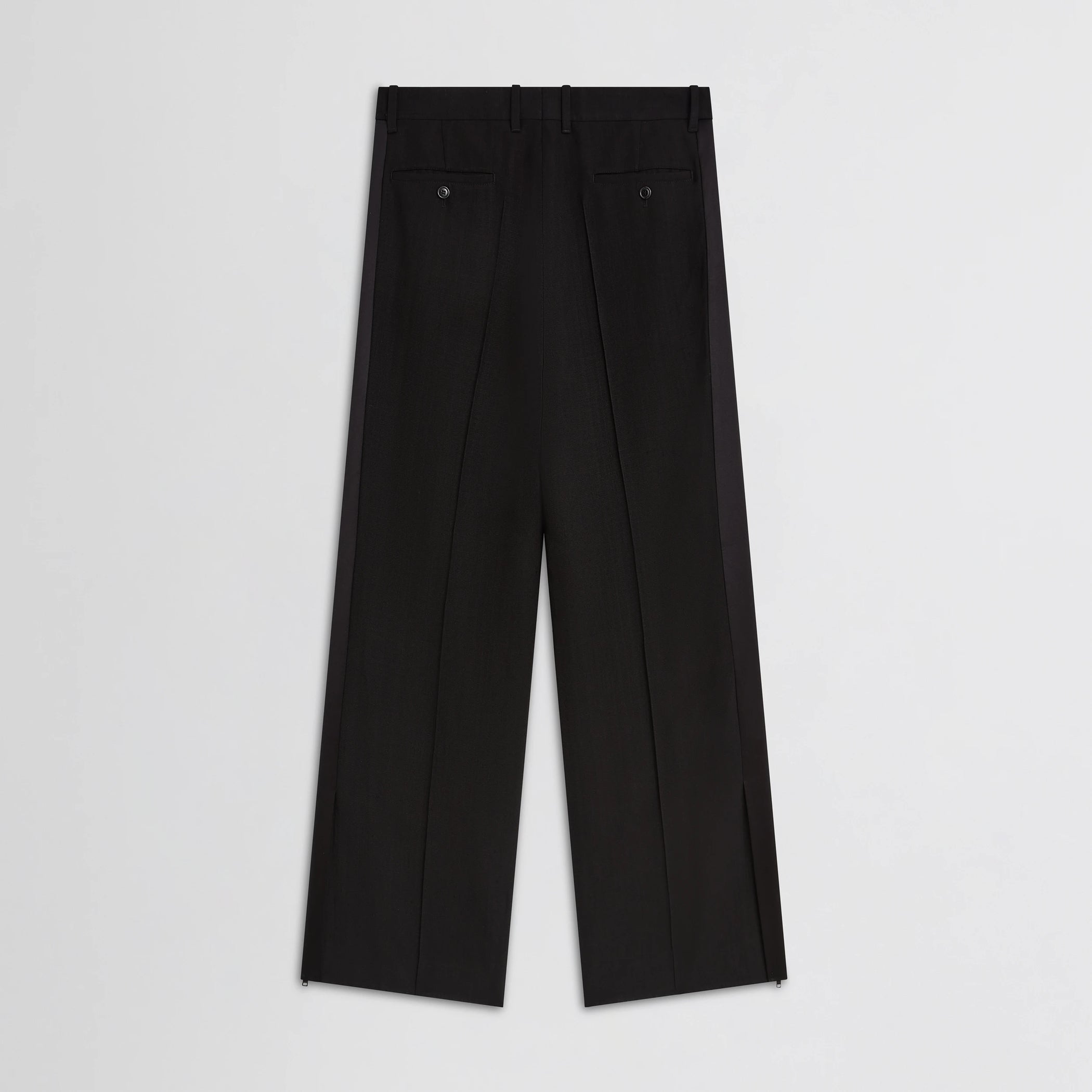 Flat back view of split tux trousers in black wool.