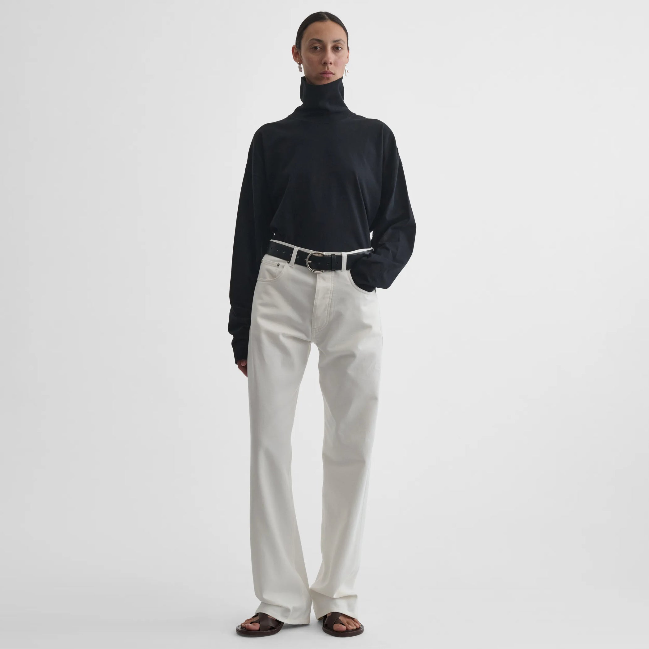 Full body front view of model wearing Classic Jeans in plaster white.