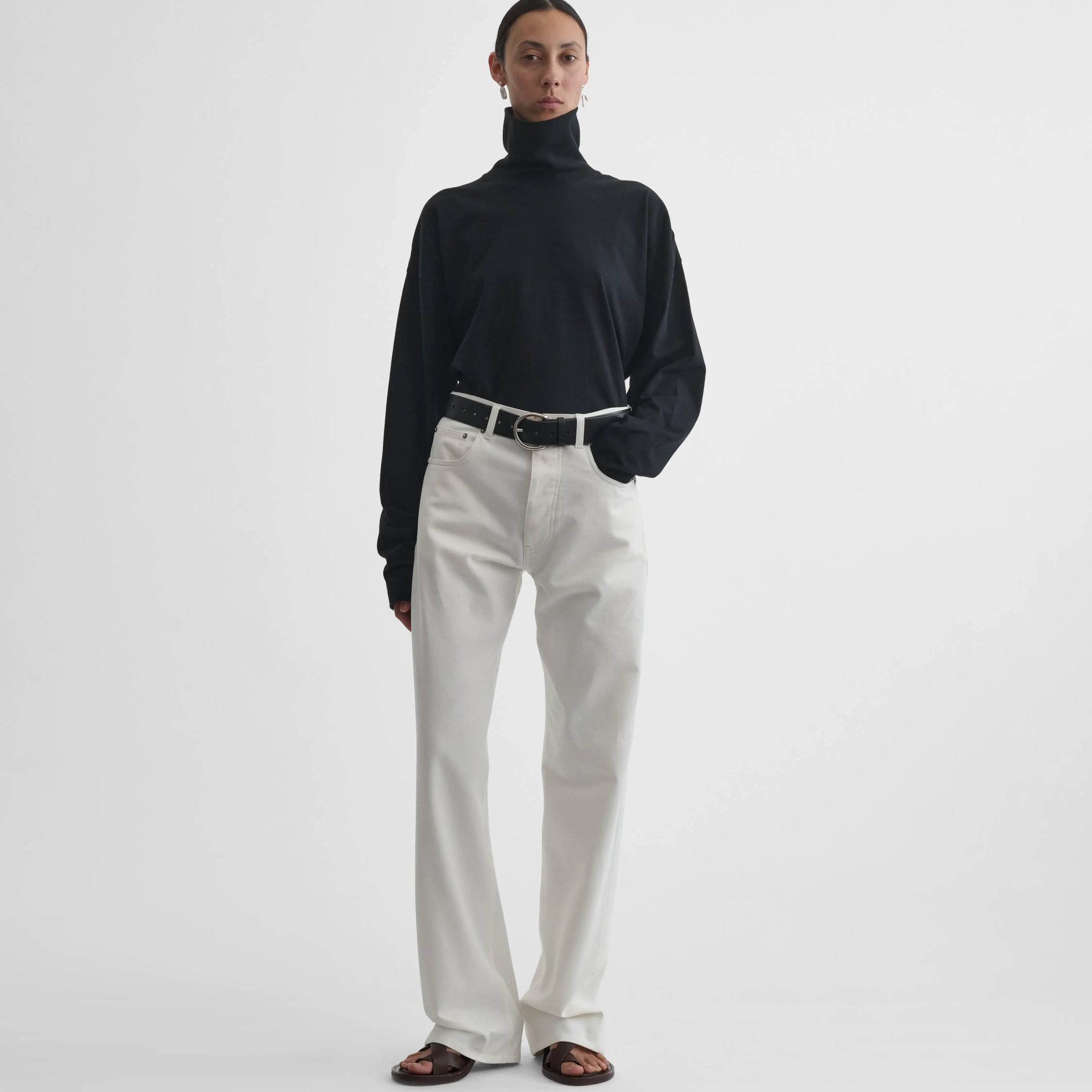 Full body front view of model wearing Classic Jeans in plaster white.