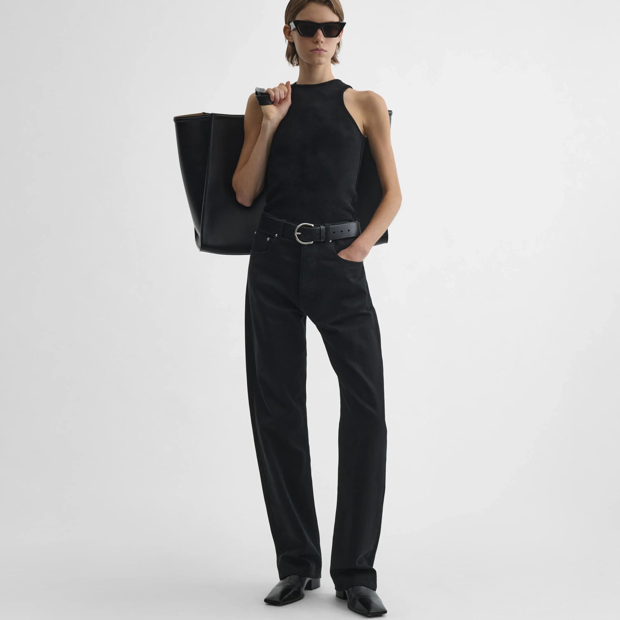 Full body front view of model wearing Classic Jeans in black. 