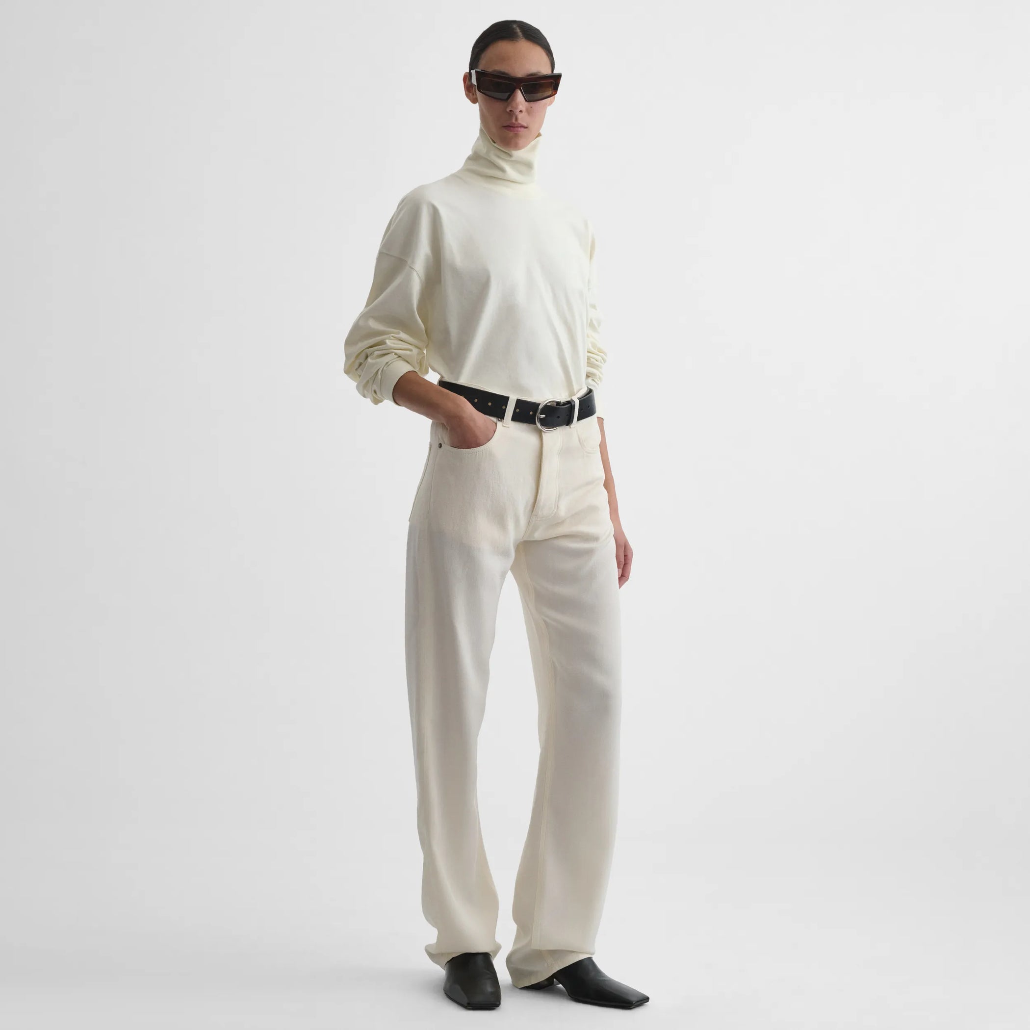 Full body front view of model wearing Classic Jeans in off white.