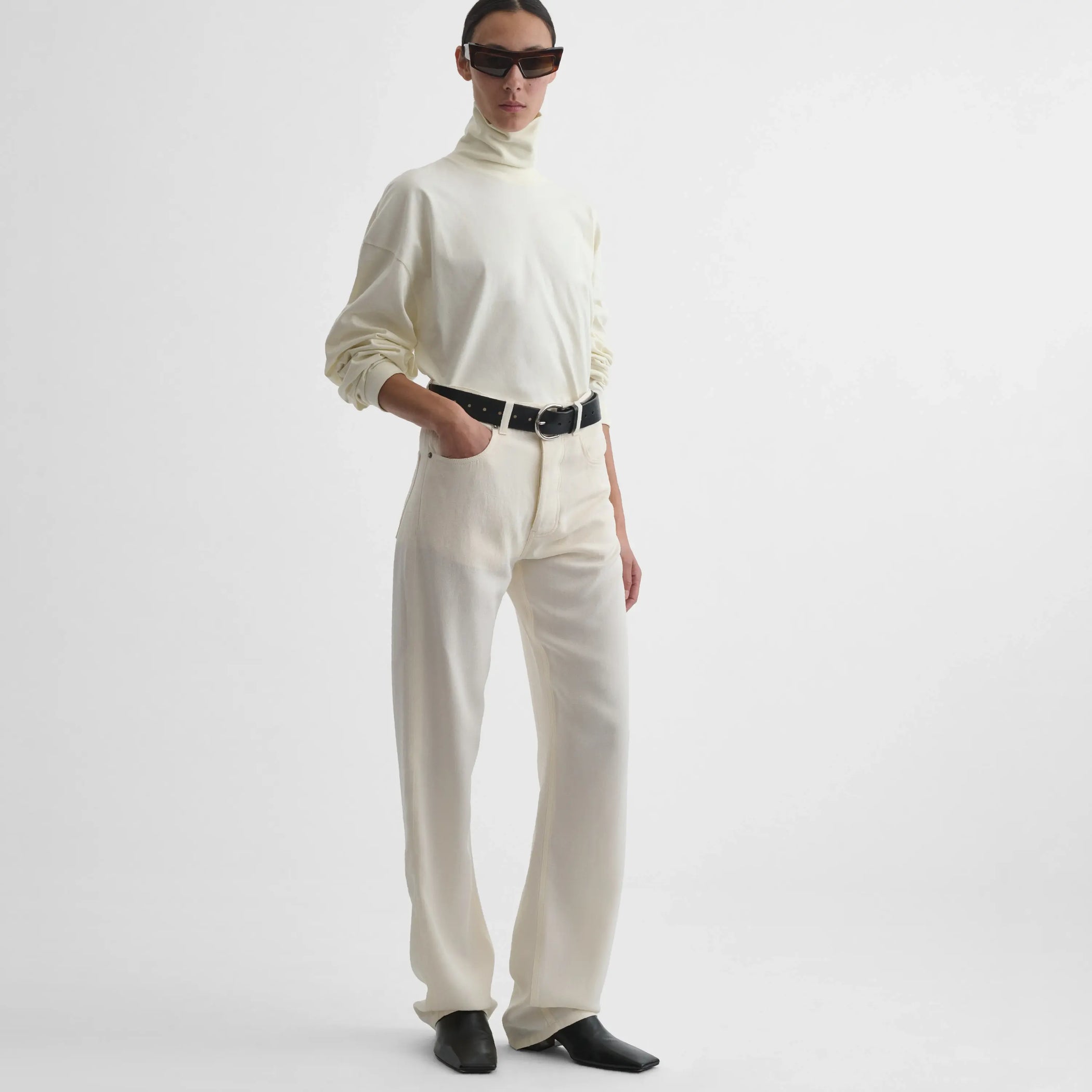 Full body front view of model wearing Classic Jeans in off white.