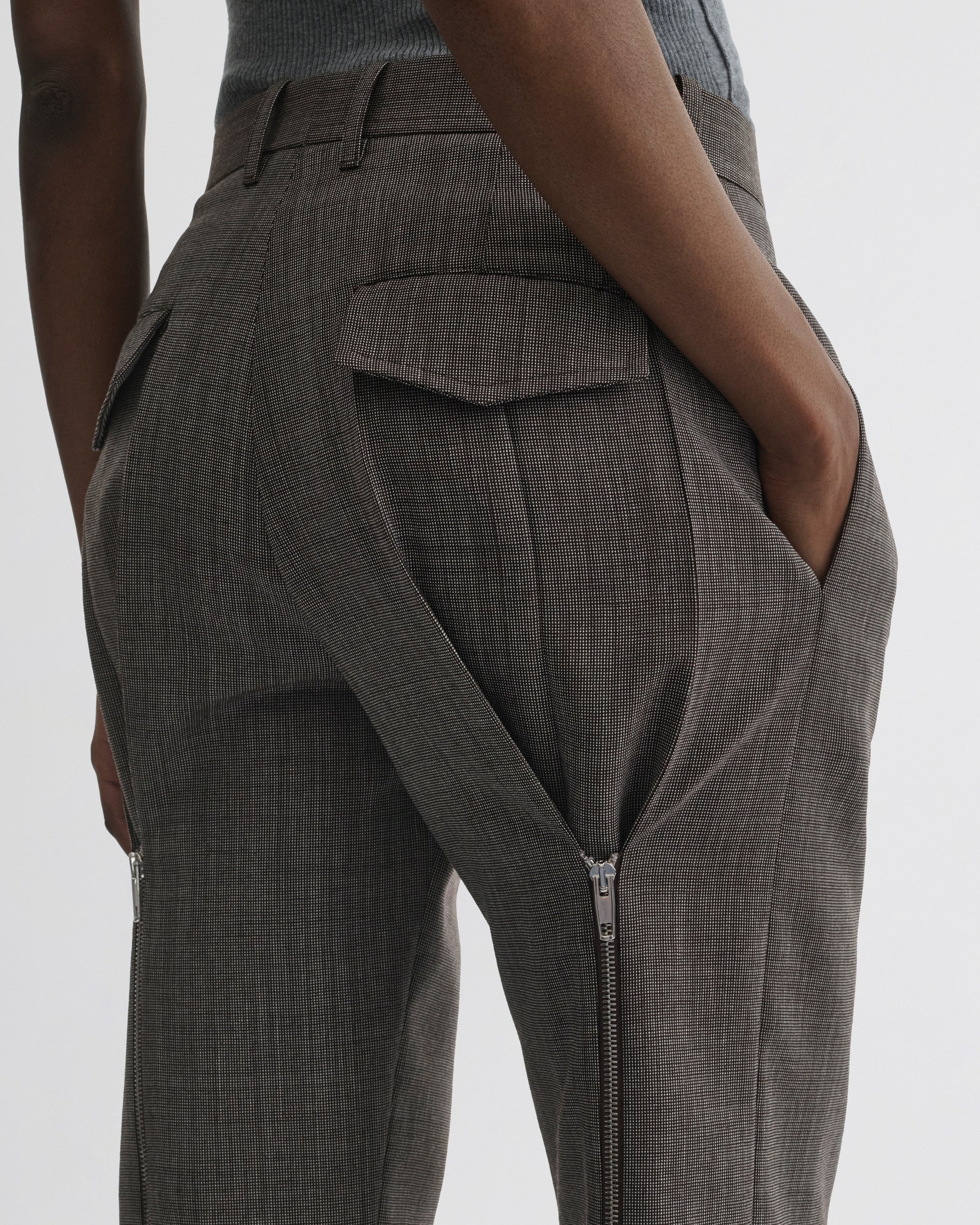 Close up detail view of Split Zip Trousers in white dark brown wool