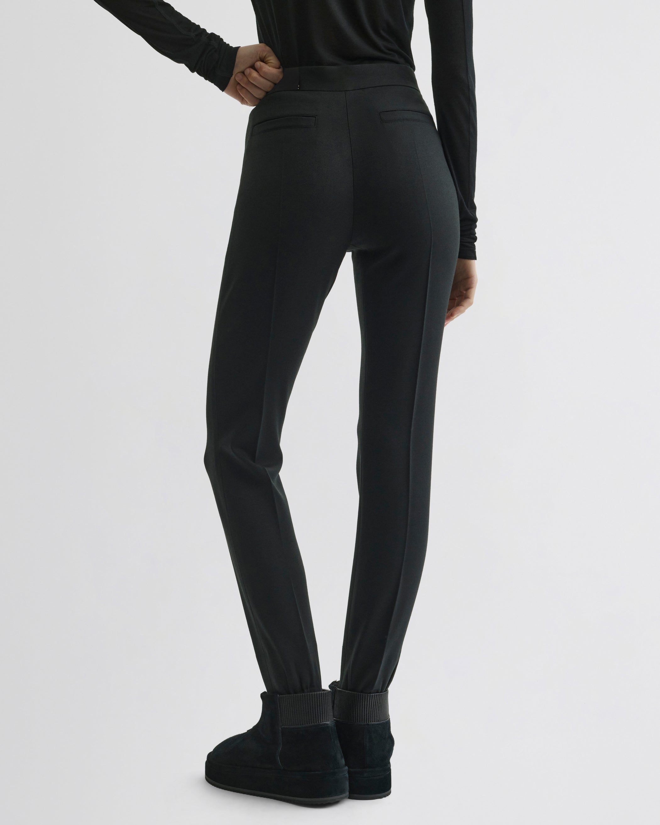 Back view of Stirrup Trousers in black wool