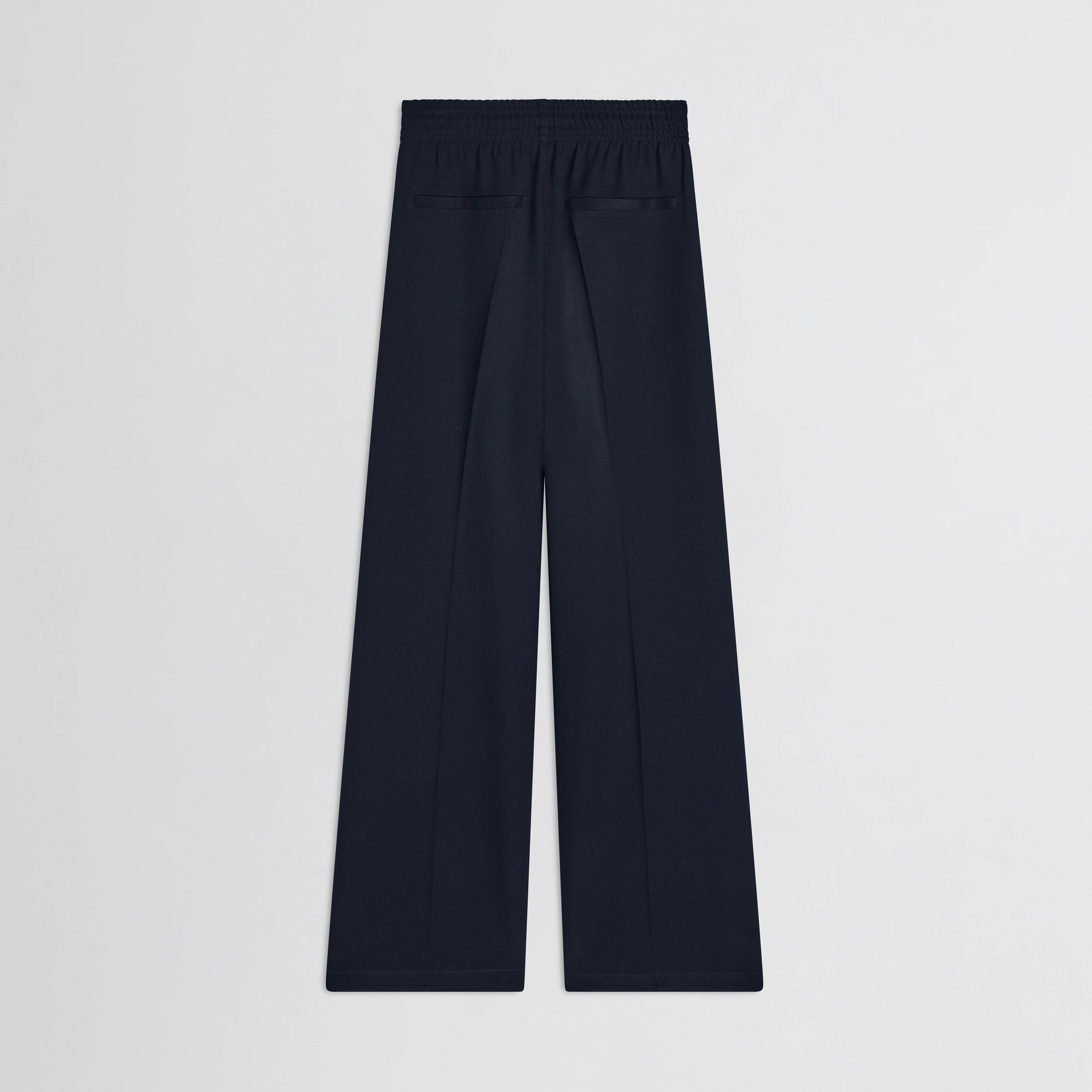 Flat back view of track trousers in navy polyester.