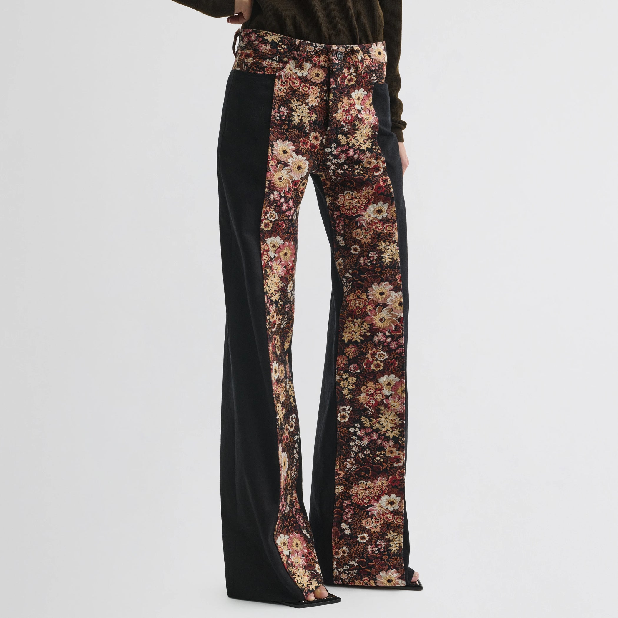 Front view of model wearing tapestry trousers in black cotton.