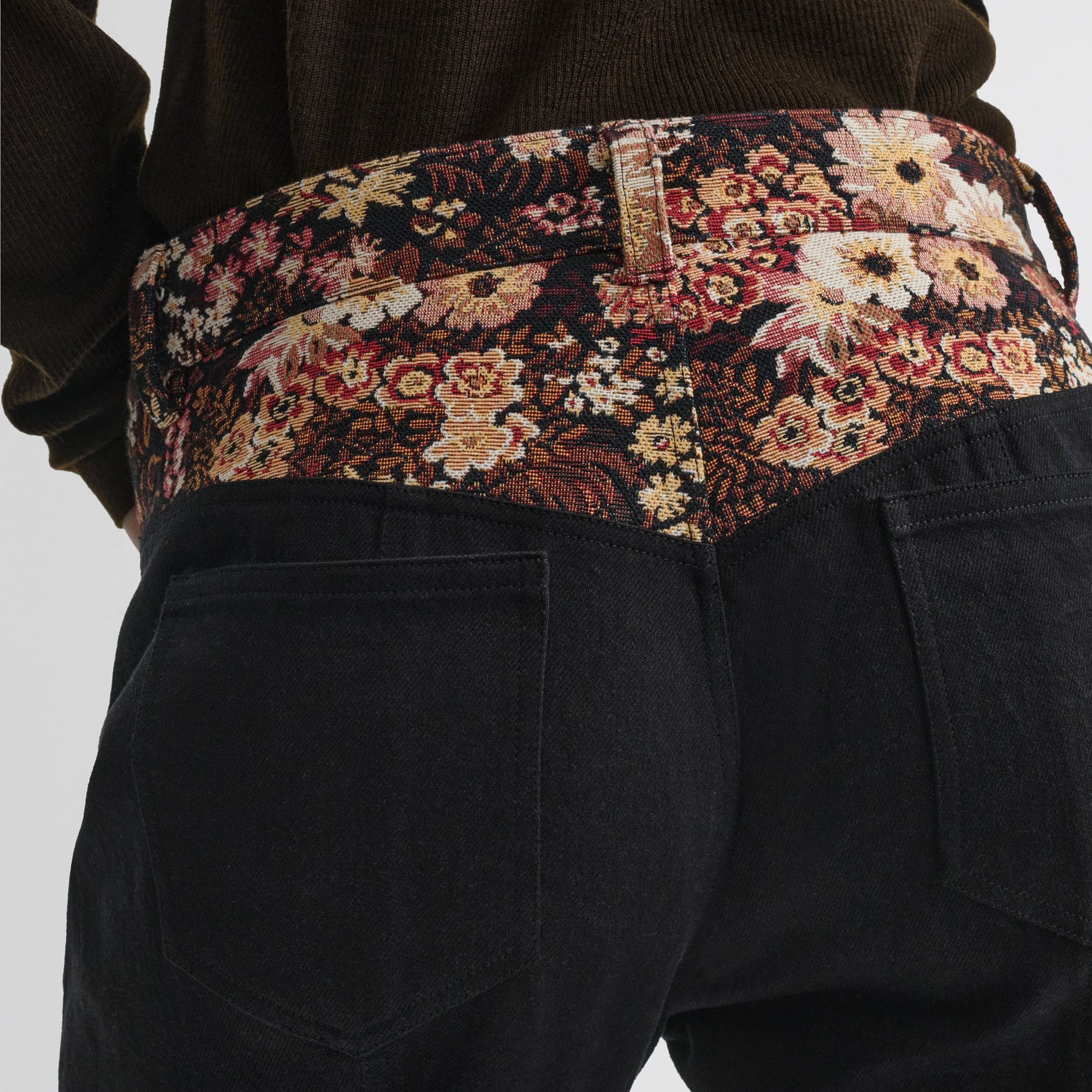 Close up detail view of tapestry trousers in black cotton.