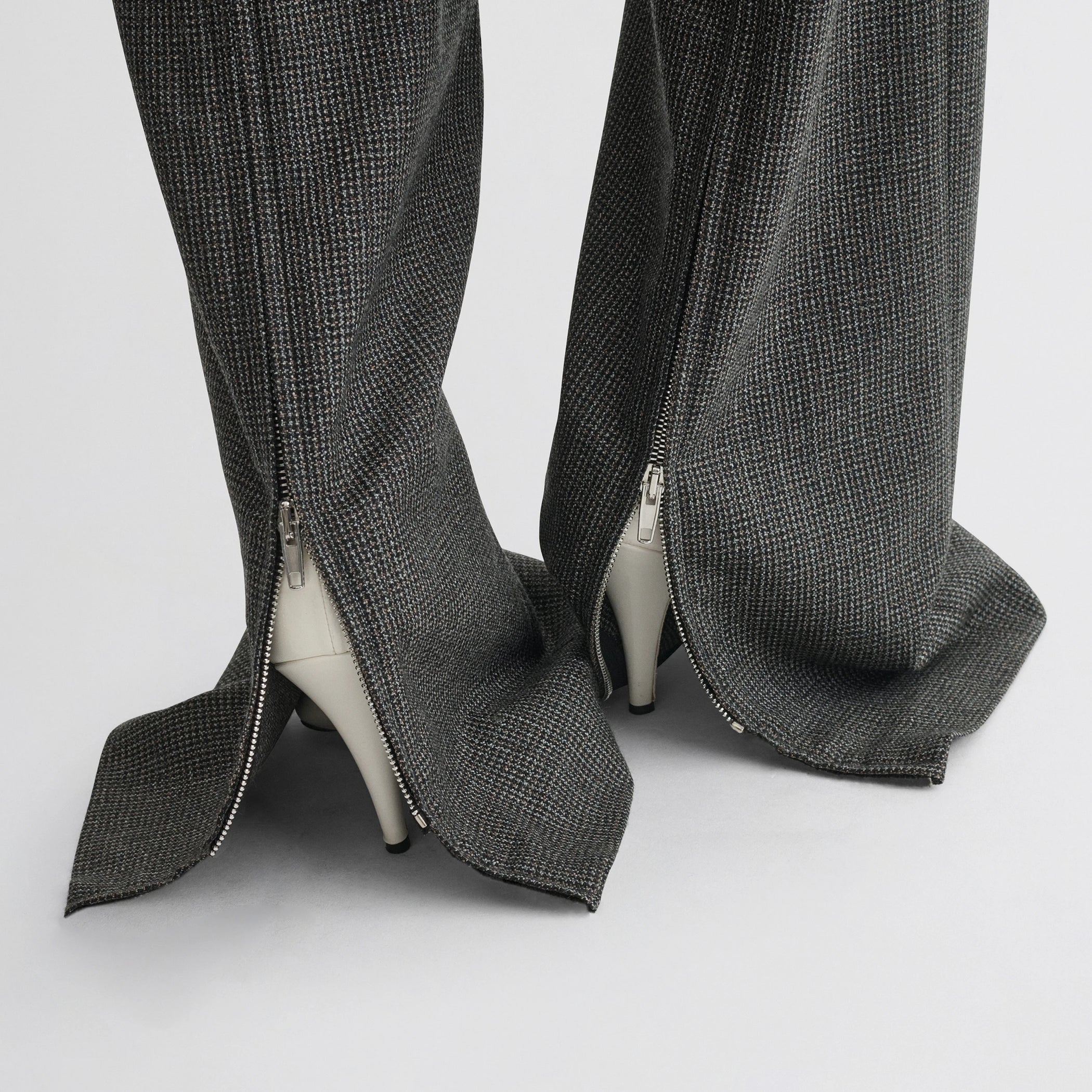 Close up detail view of zip trousers in green bronze wool.