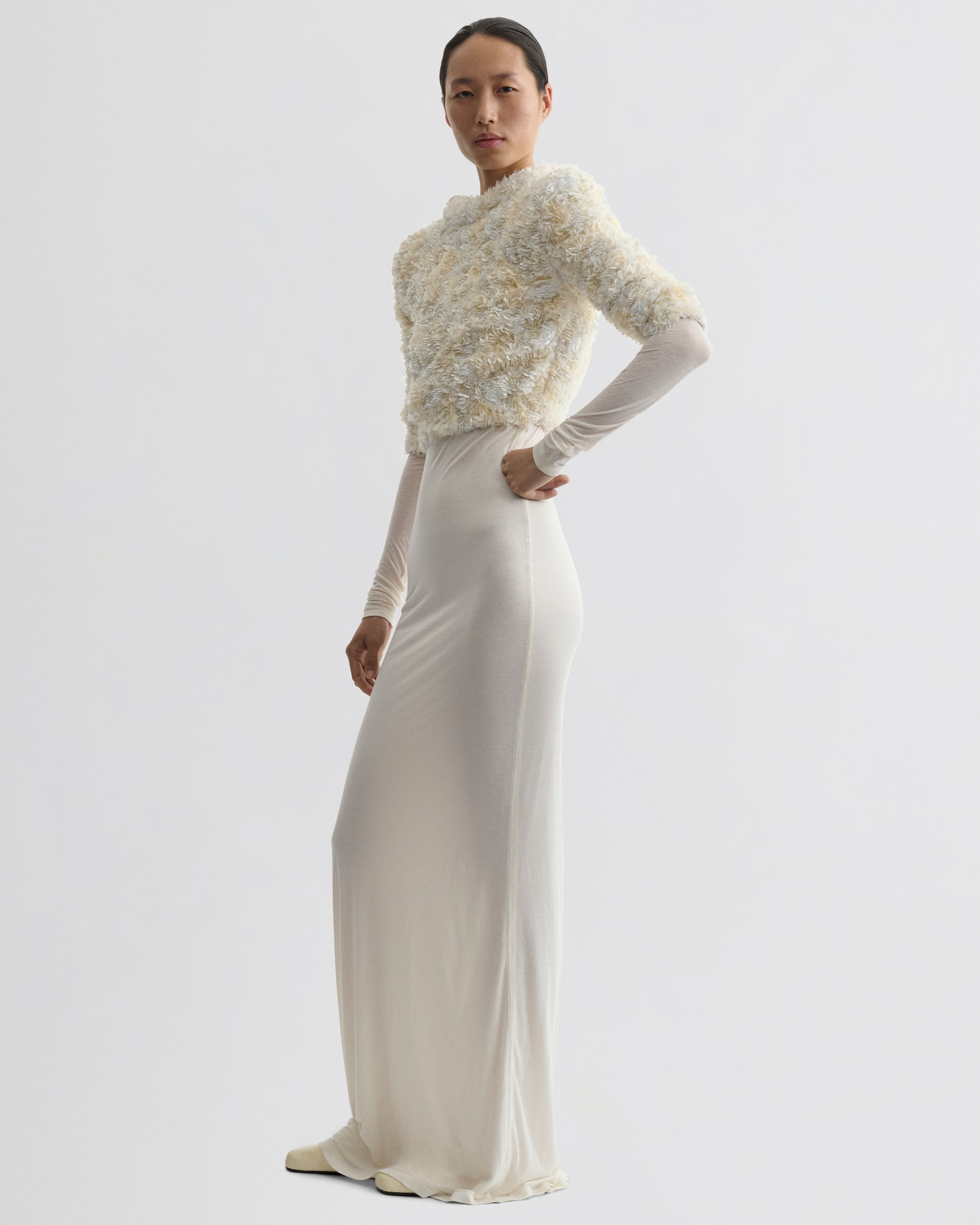 Side view of model wearing CLUSTERED SEQUIN DRESS in ivory jersey