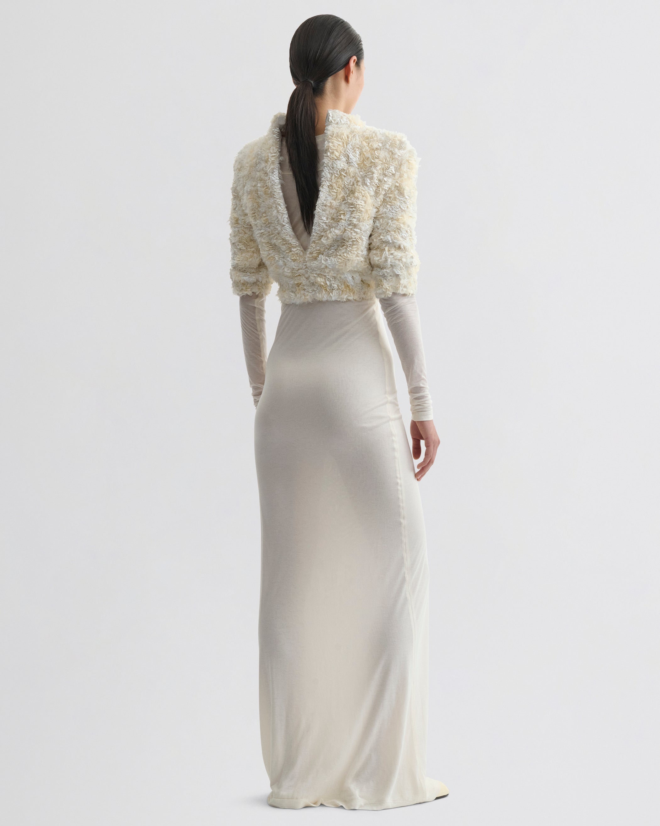 Back view of model wearing CLUSTERED SEQUIN DRESS in ivory jersey