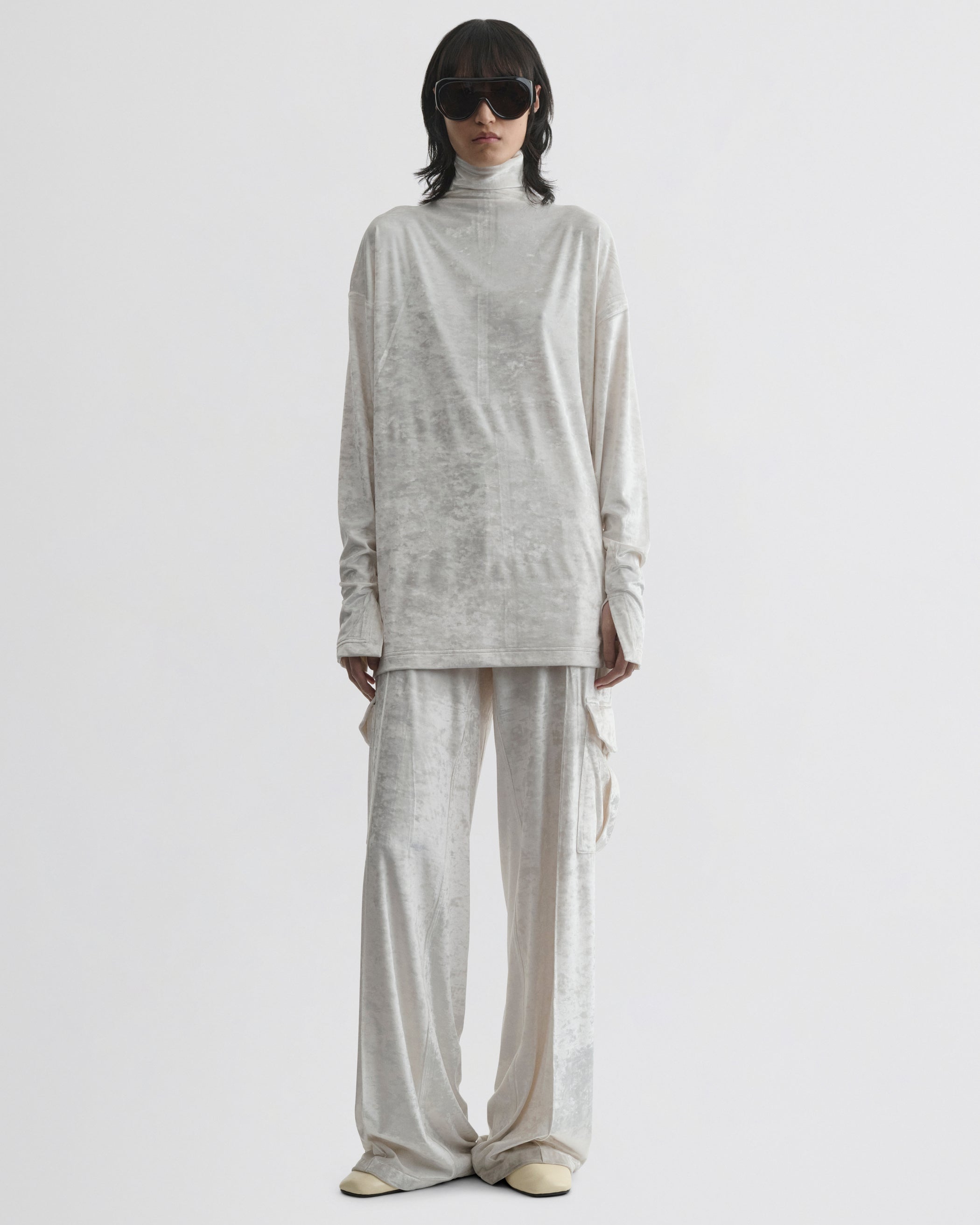 Front view of model wearing LIQUID HIGH NECK TOP in white crushed velvet