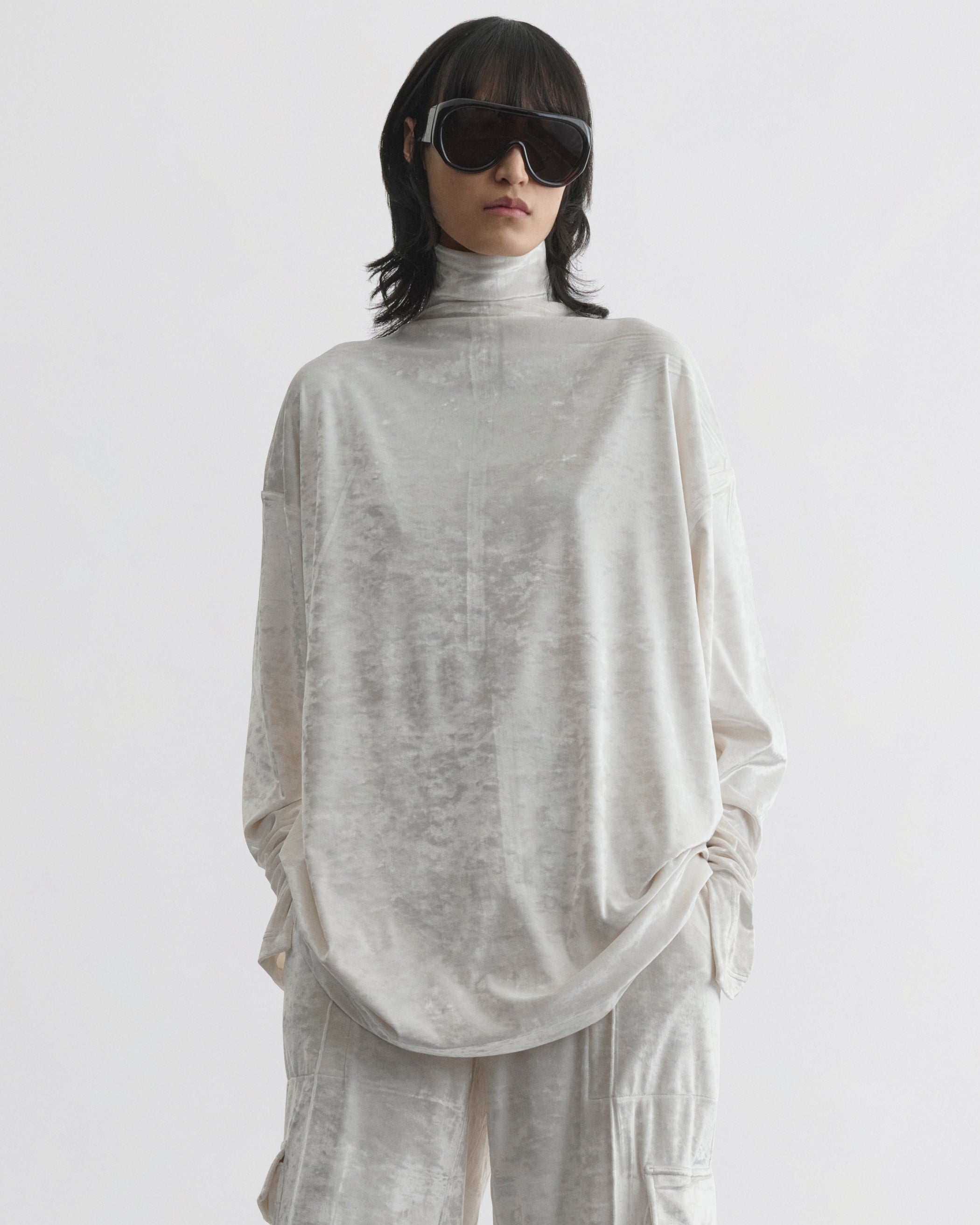 Front view of model wearing LIQUID HIGH NECK TOP in white crushed velvet
