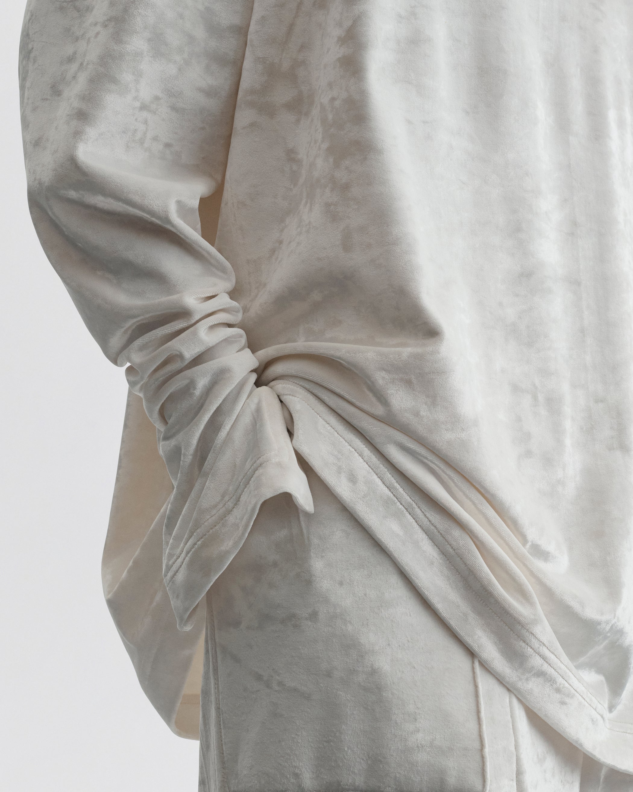 Close up detail view of LIQUID HIGH NECK TOP in white crushed velvet