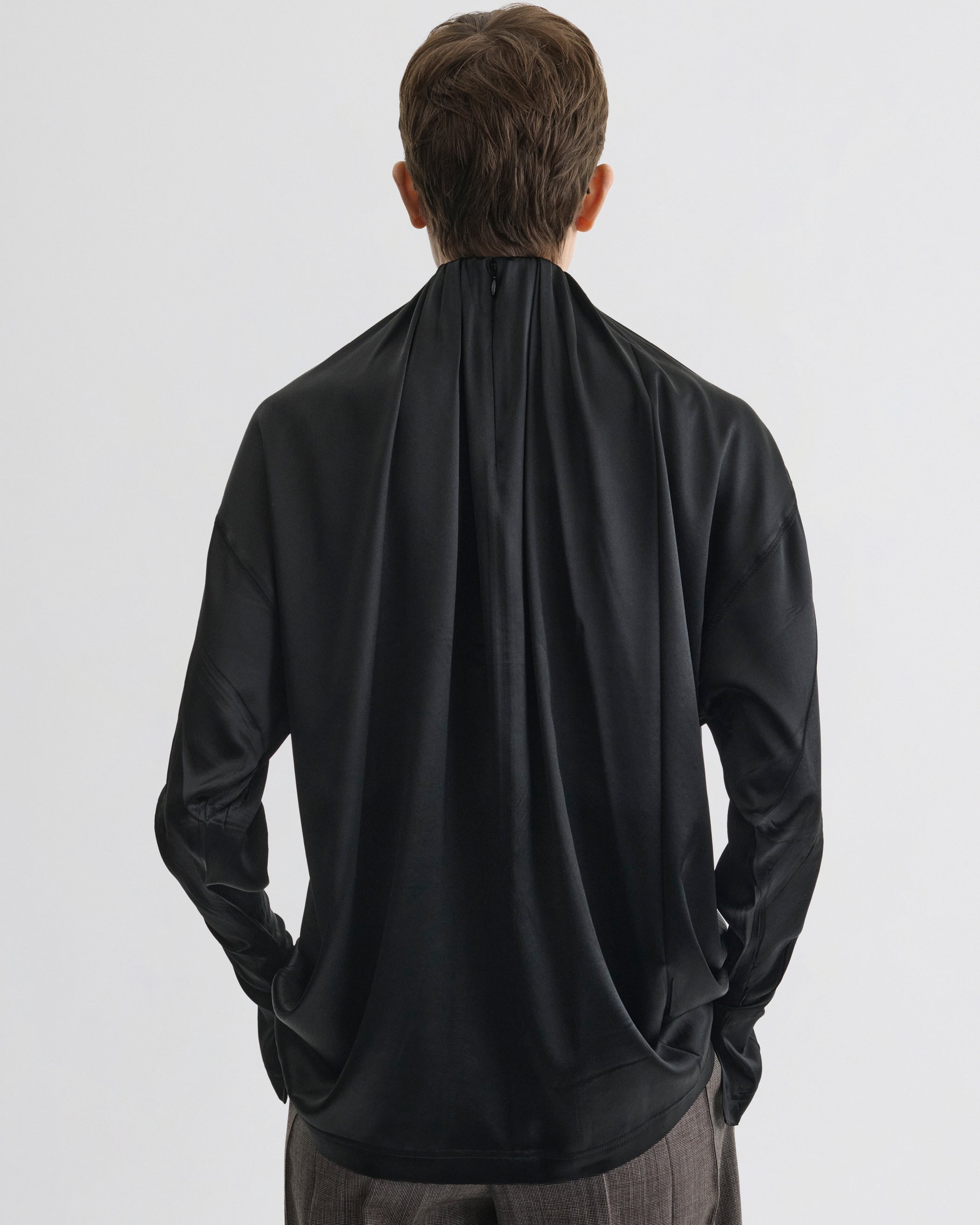 Back view of model wearing LIQUID SOFT RIDGE TOP in black silk
