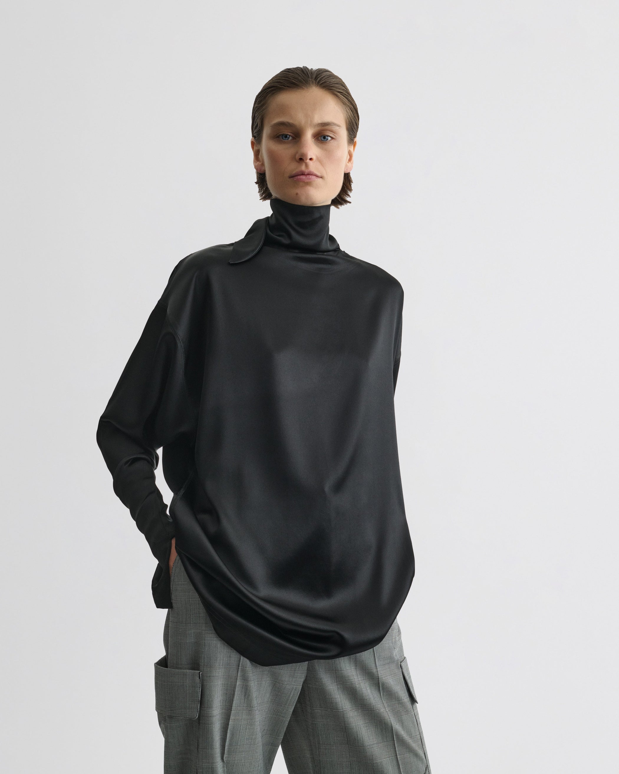 Front view of model wearing LIQUID KNOT COLLAR TOP in black silk