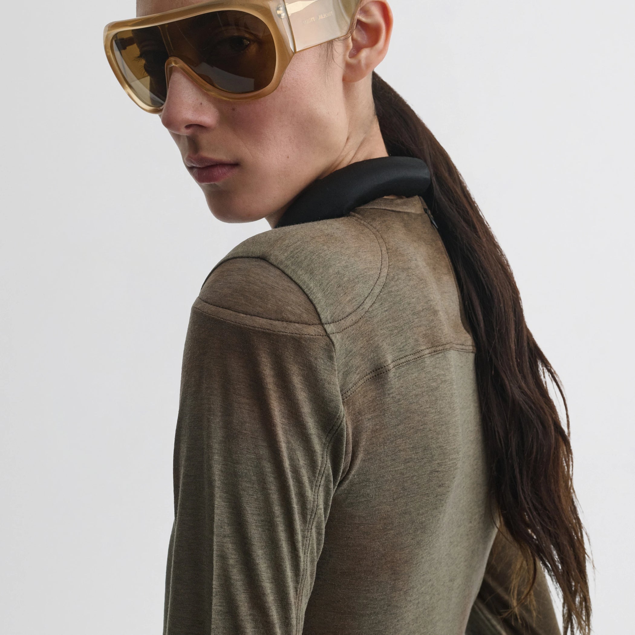 Side view of model wearing tubular top in tobacco black cotton.