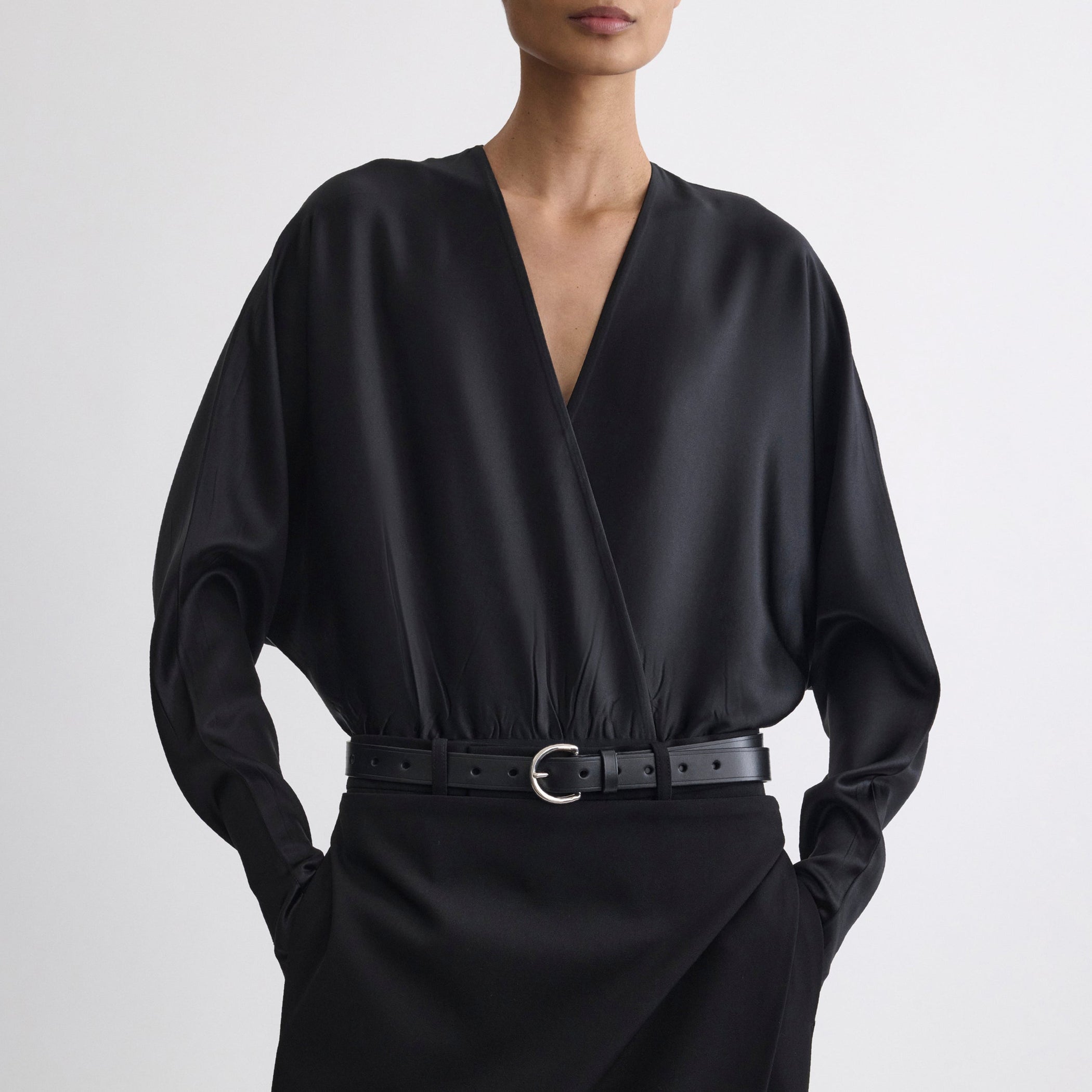 Close up front view of model wearing BATWING BODY in black silk satin