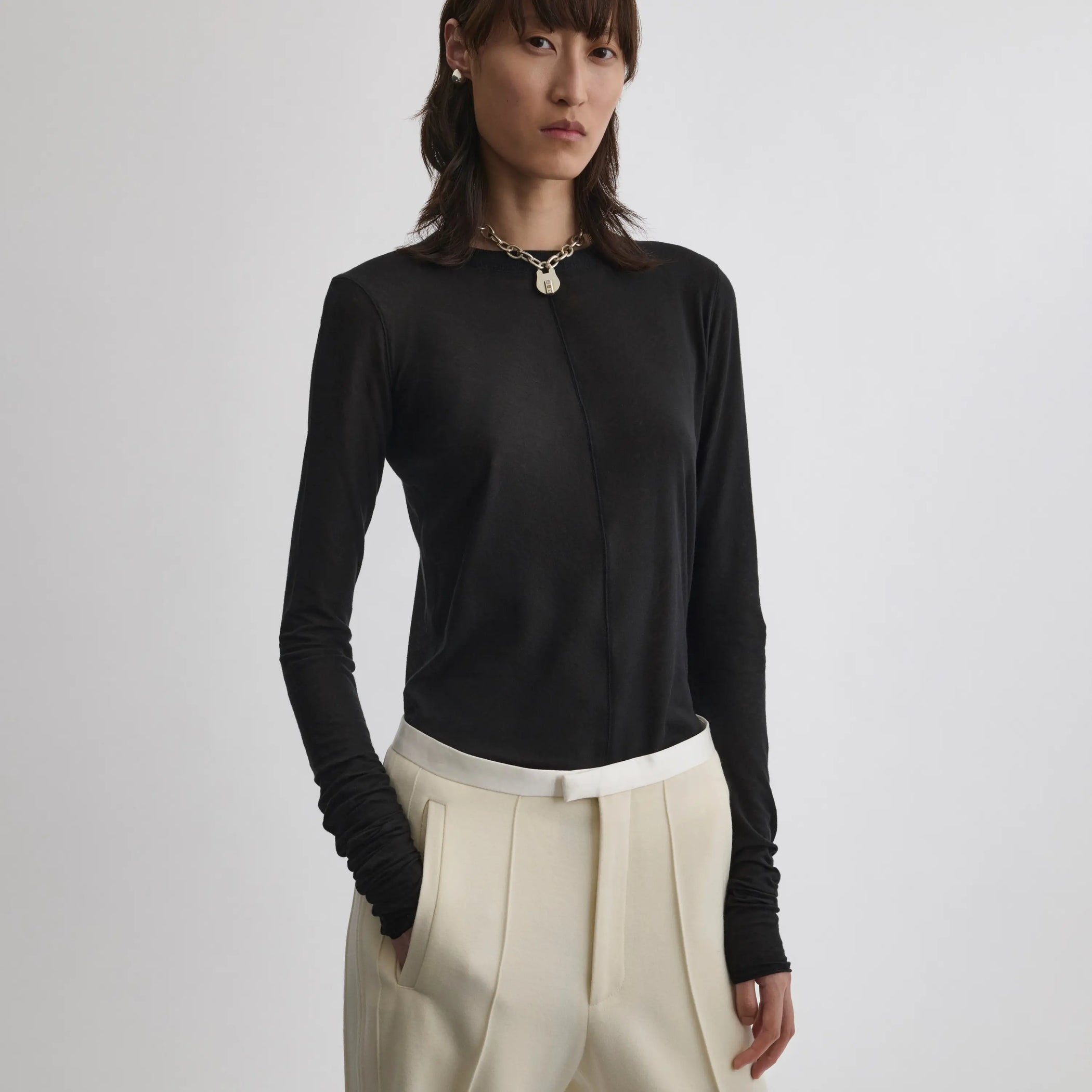 Front view of model wearing crew neck top in black