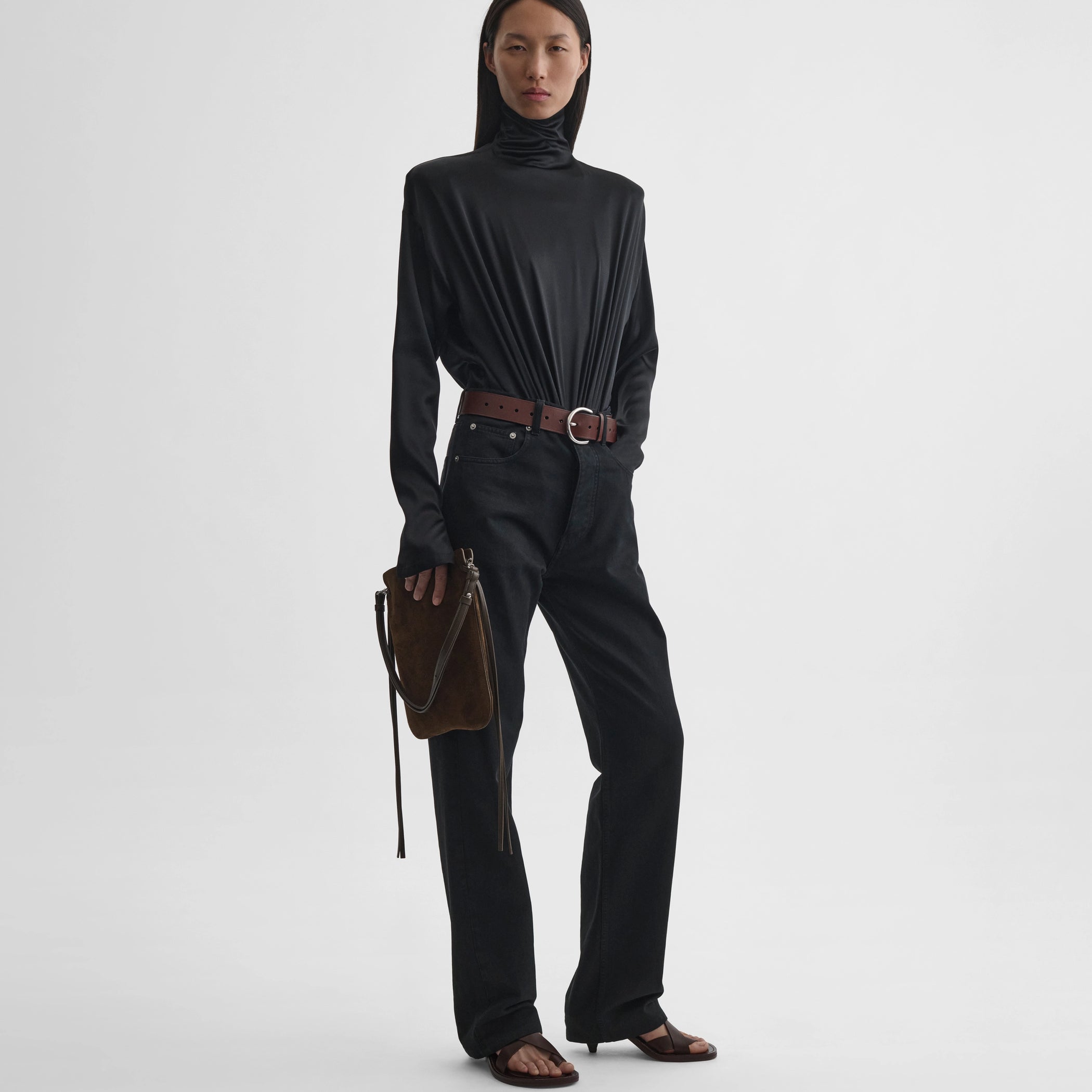 Front full body view of model wearing sharp shoulder body in black silk satin