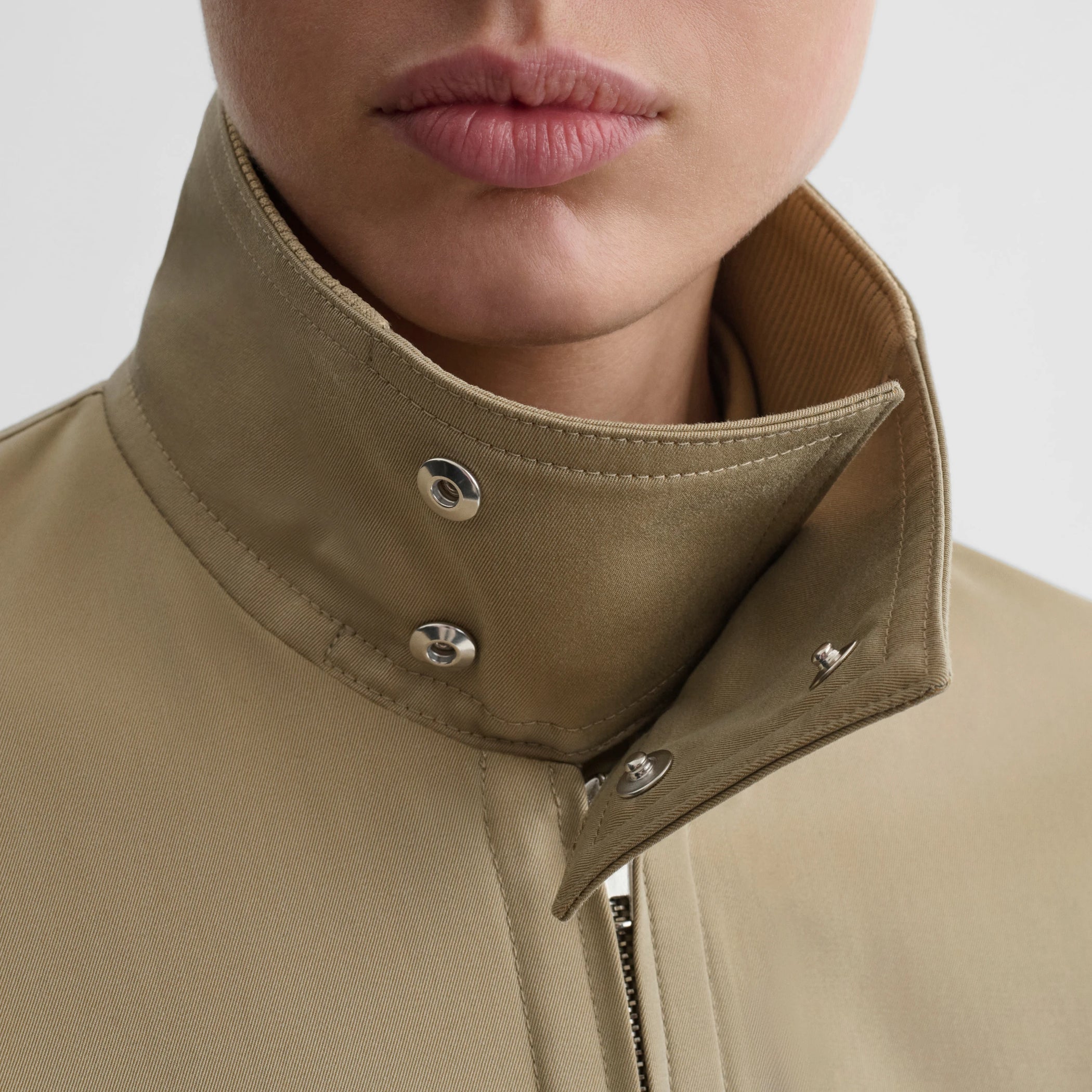 Close up detail view of golf jacket in trench cotton.