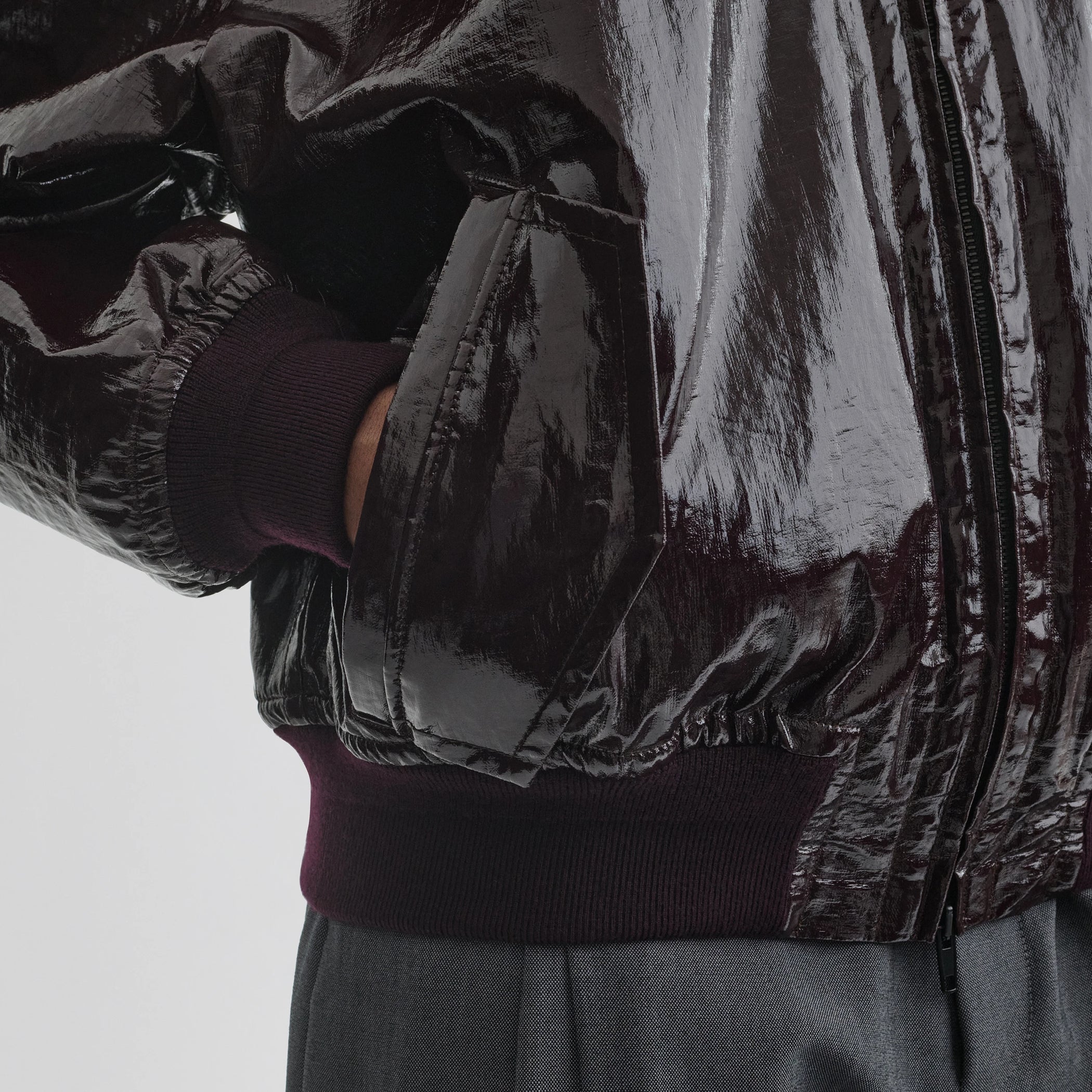 Close up detail view of golf jacket in burgundy linen canvas.