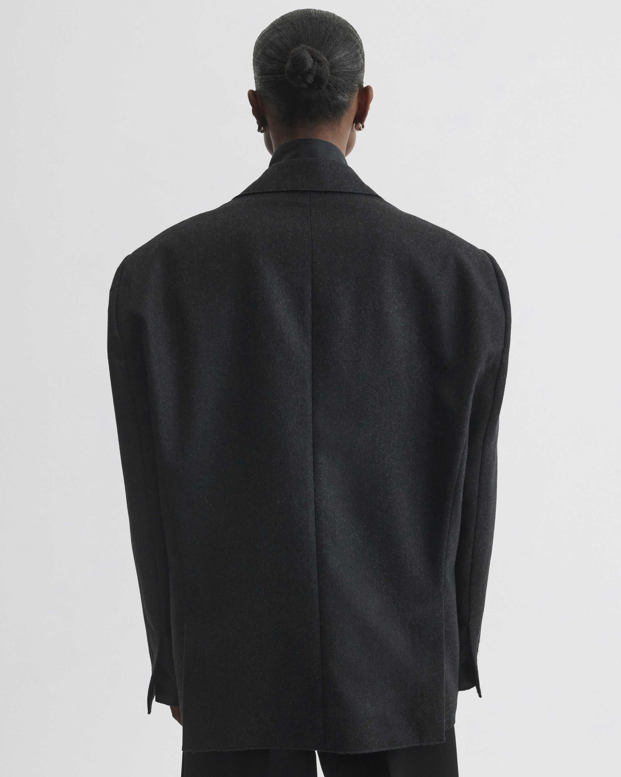 Back view of model wearing Tuxedo Jacket in anthracite wool