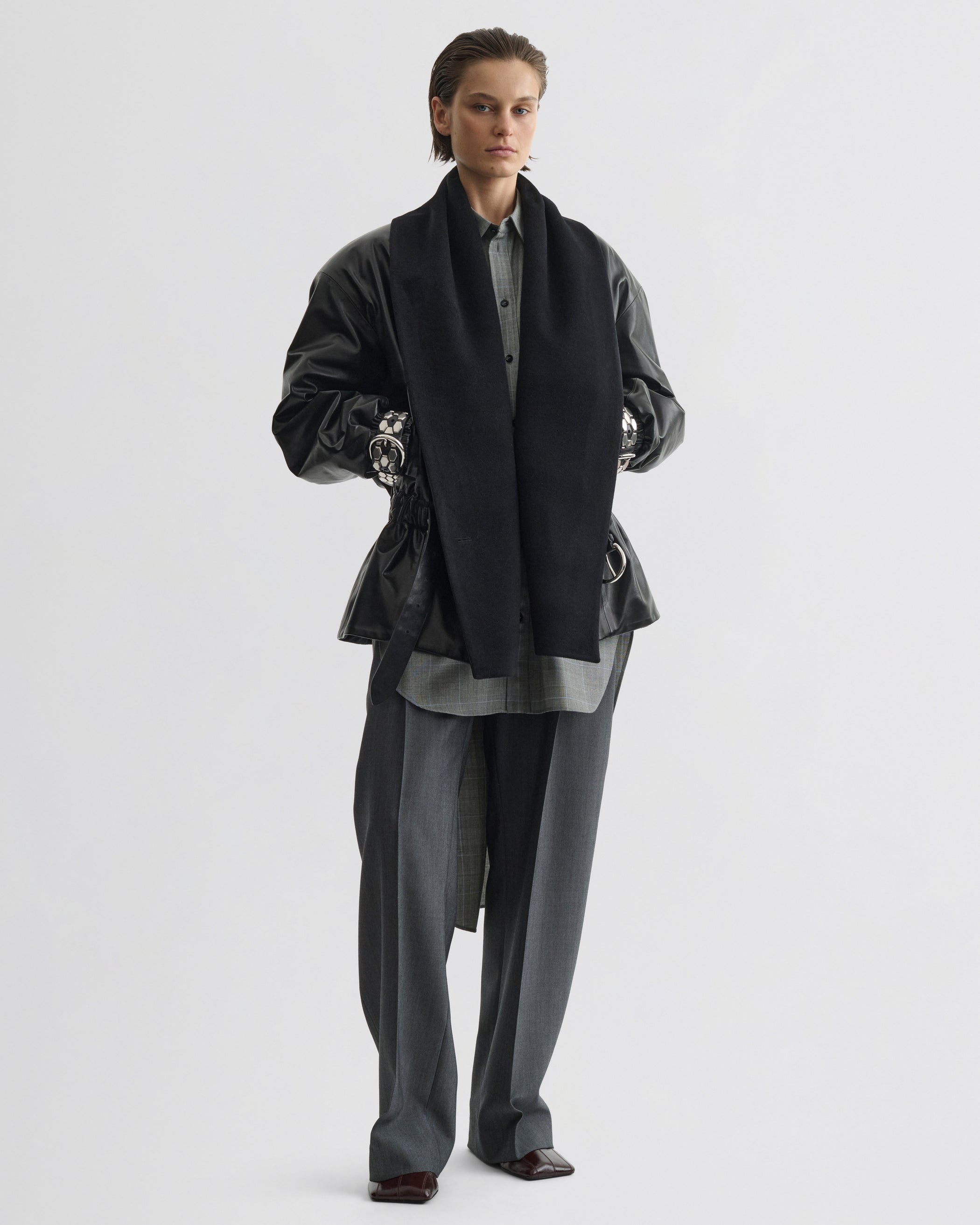 Front view of model wearing Stud Jacket in black leather