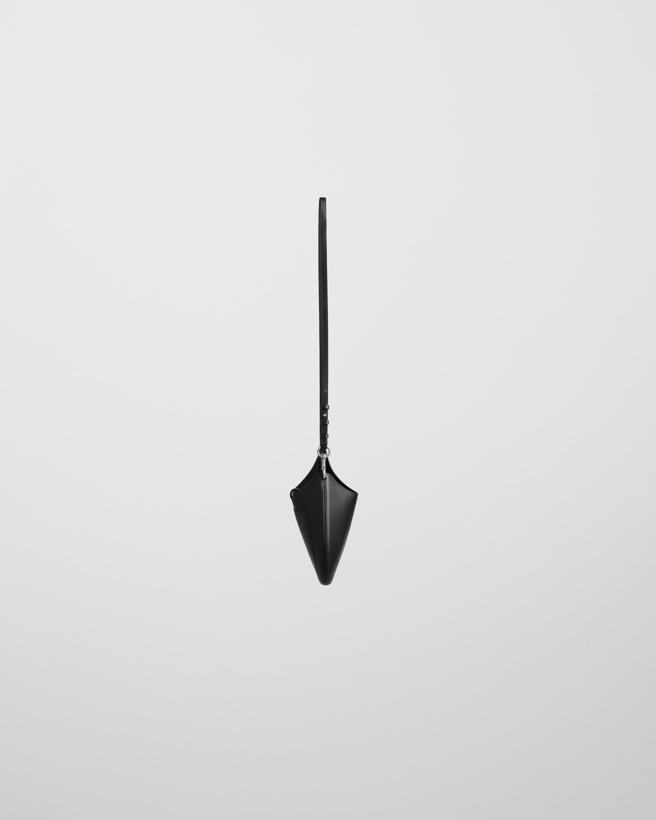 Side view of MINI BEAN SLING in black leather