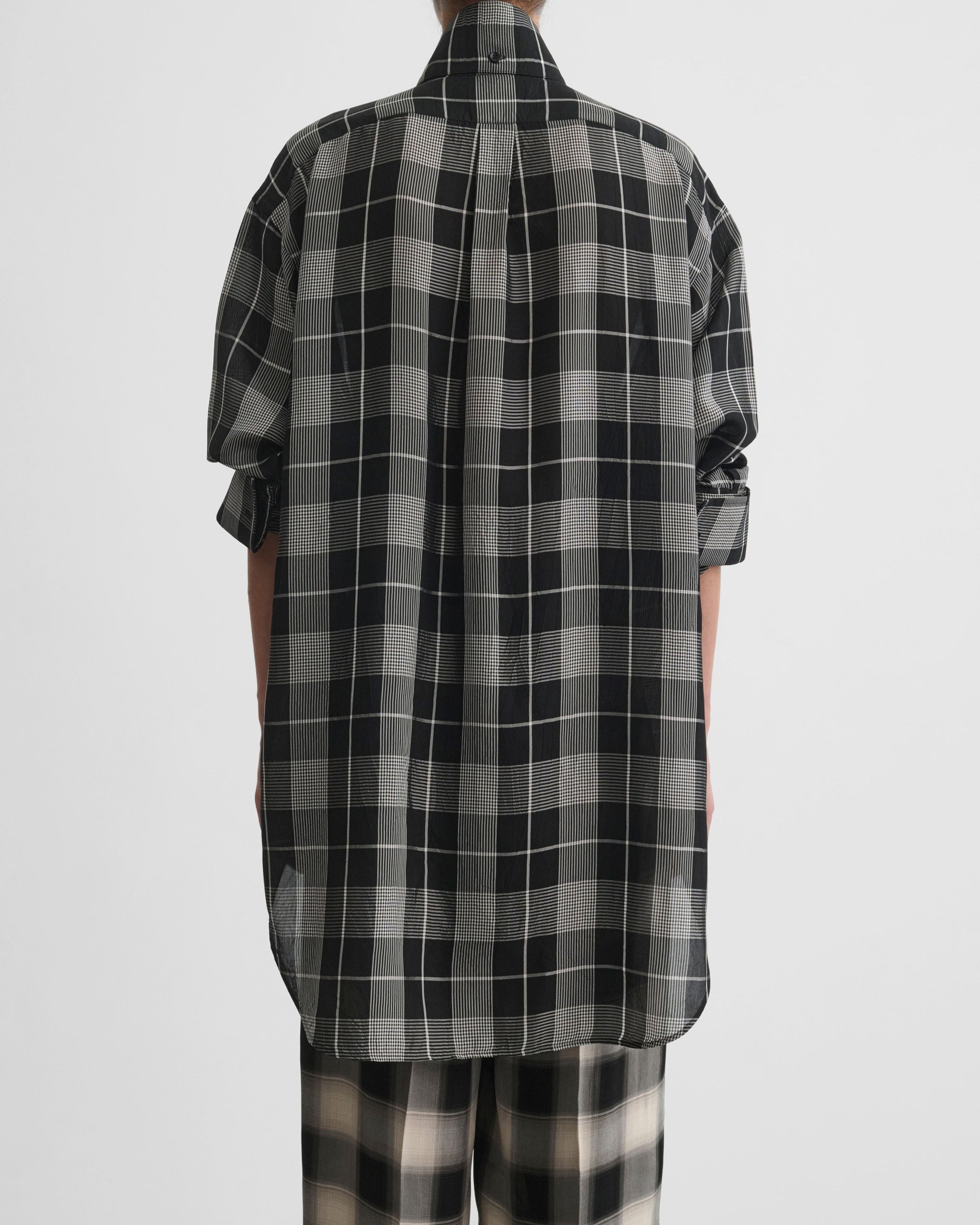Back view of model wearing CUSTOM TUX SHIRT in b/w check viscose