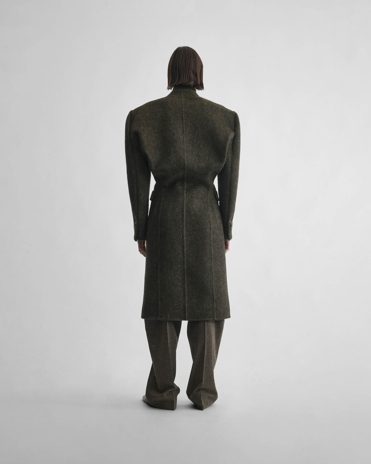 Back view of model wearing KINKED JACKET in anthracite wool