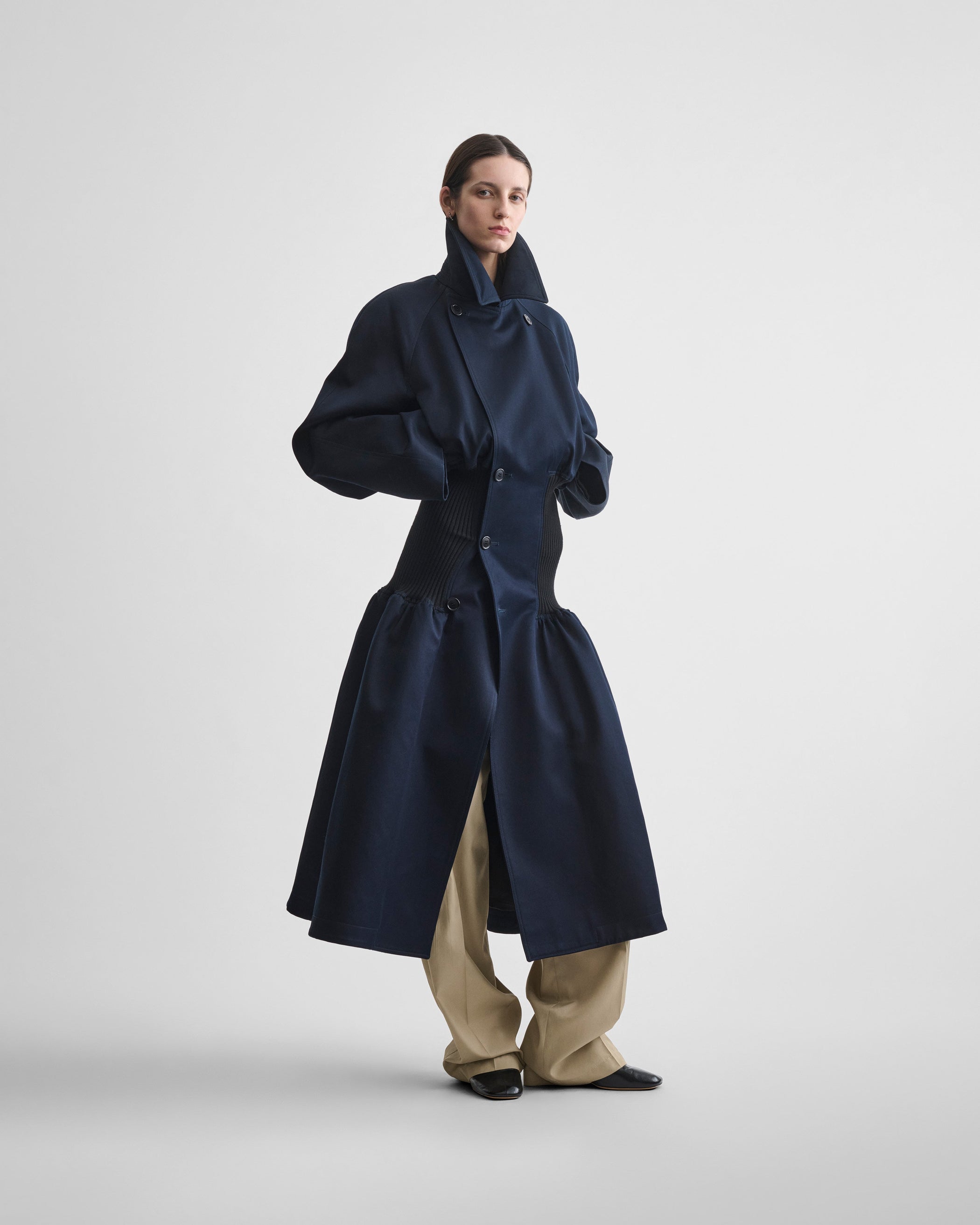 Front full length view of model wearing KICK COAT in dark navy cotton
