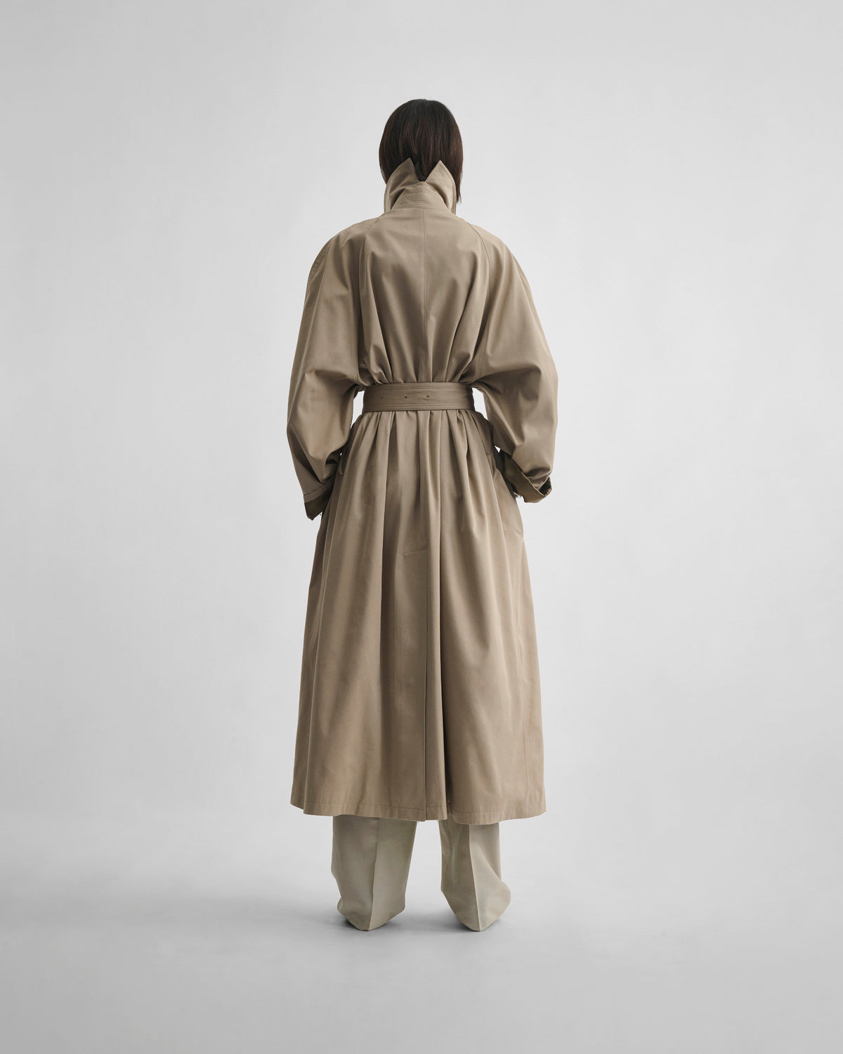 Back view of model wearing BIG TRENCH in sand cotton