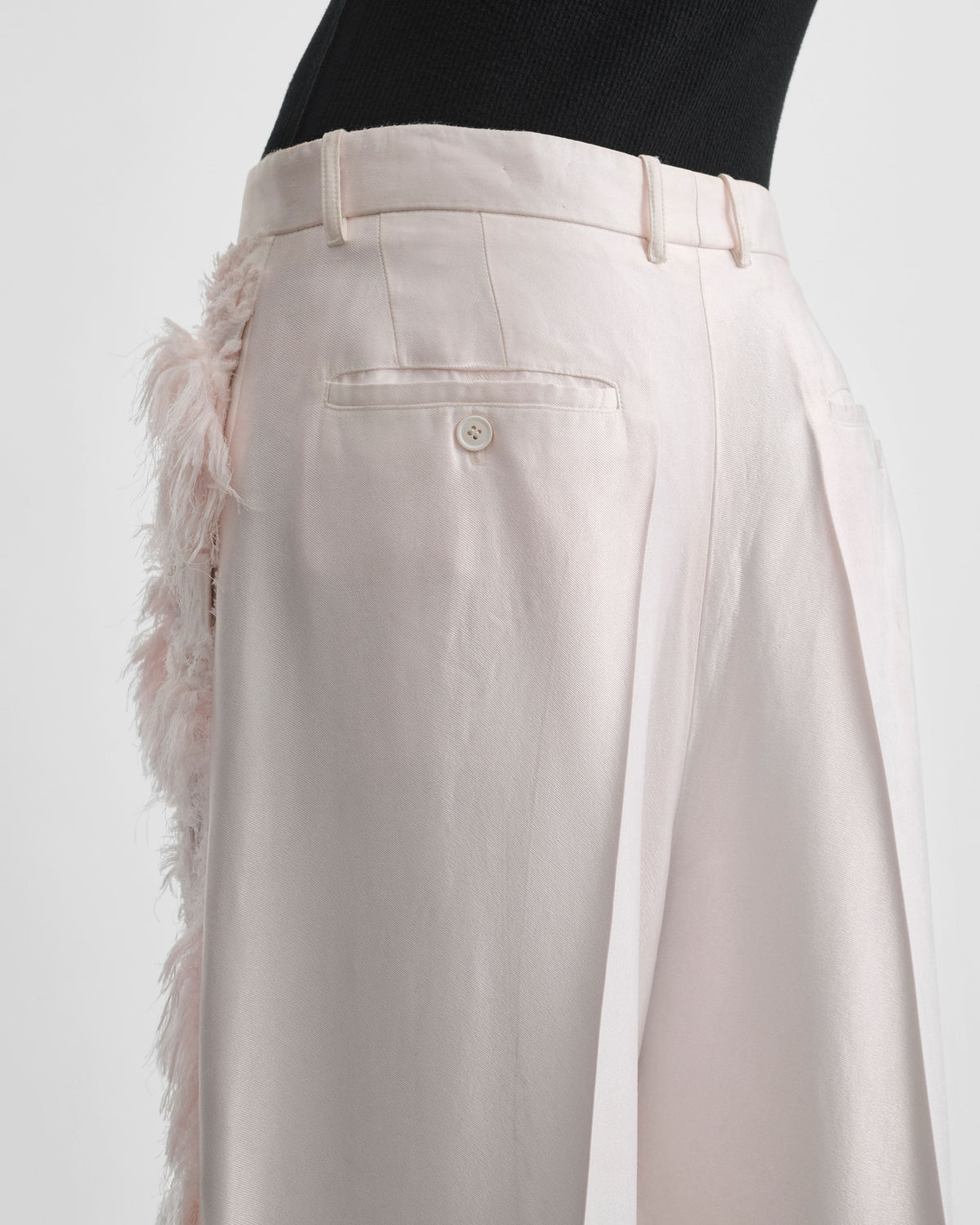 Back detail view of model wearing COMBED EMBROIDERED TROUSERS in floss viscose