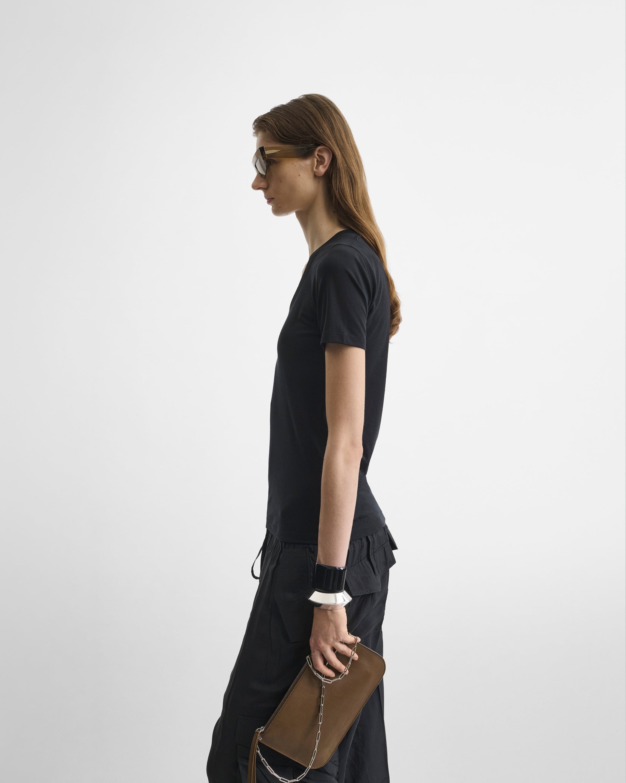 Side view of model wearing SCOOP T. in black cotton