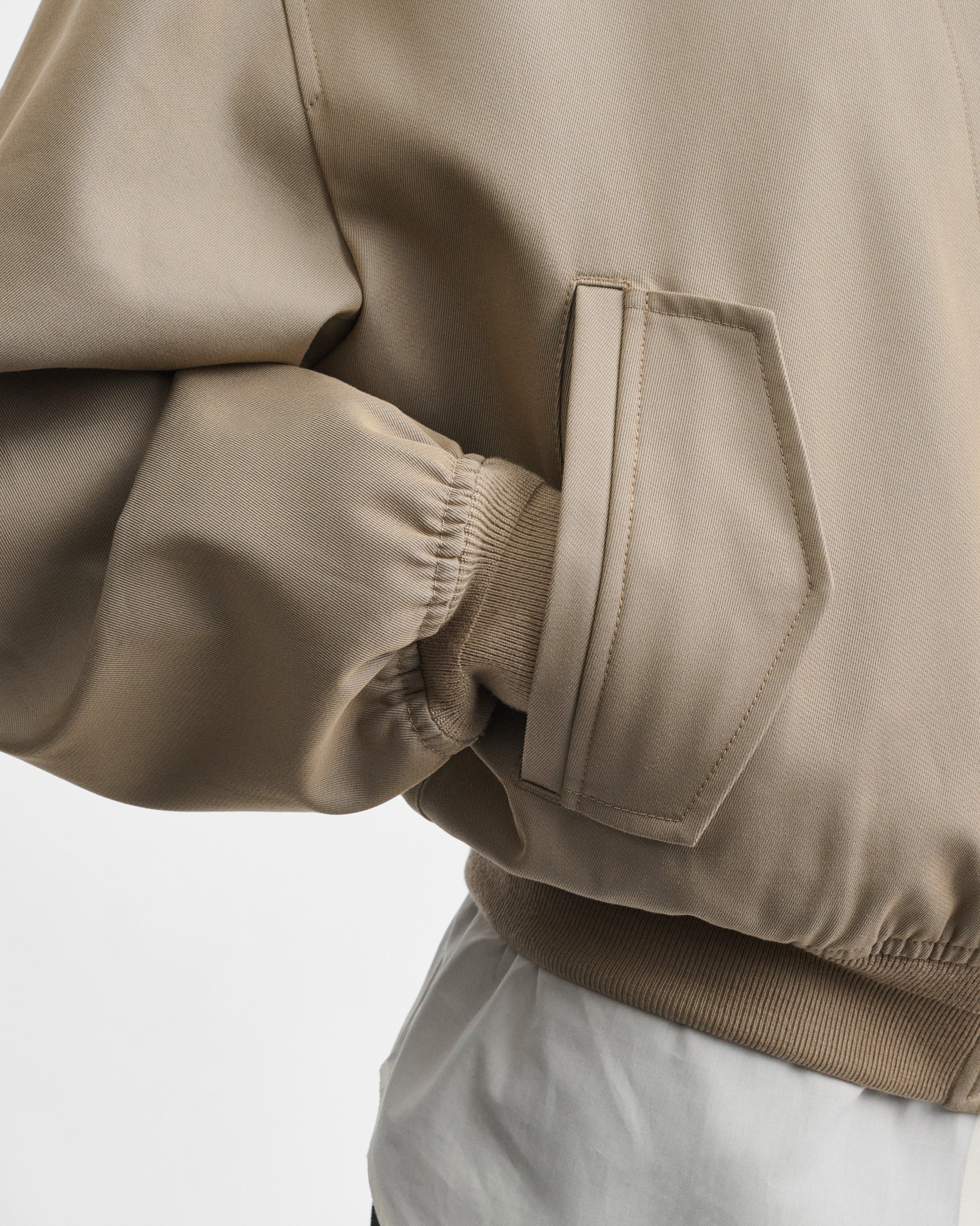 Close up view of model wearing the HARRINGTON JACKET in desert cotton