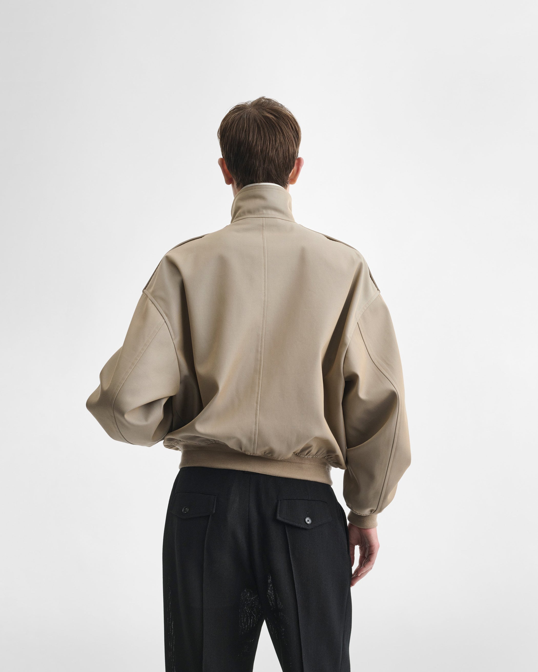 Back view of model wearing the HARRINGTON JACKET in desert cotton