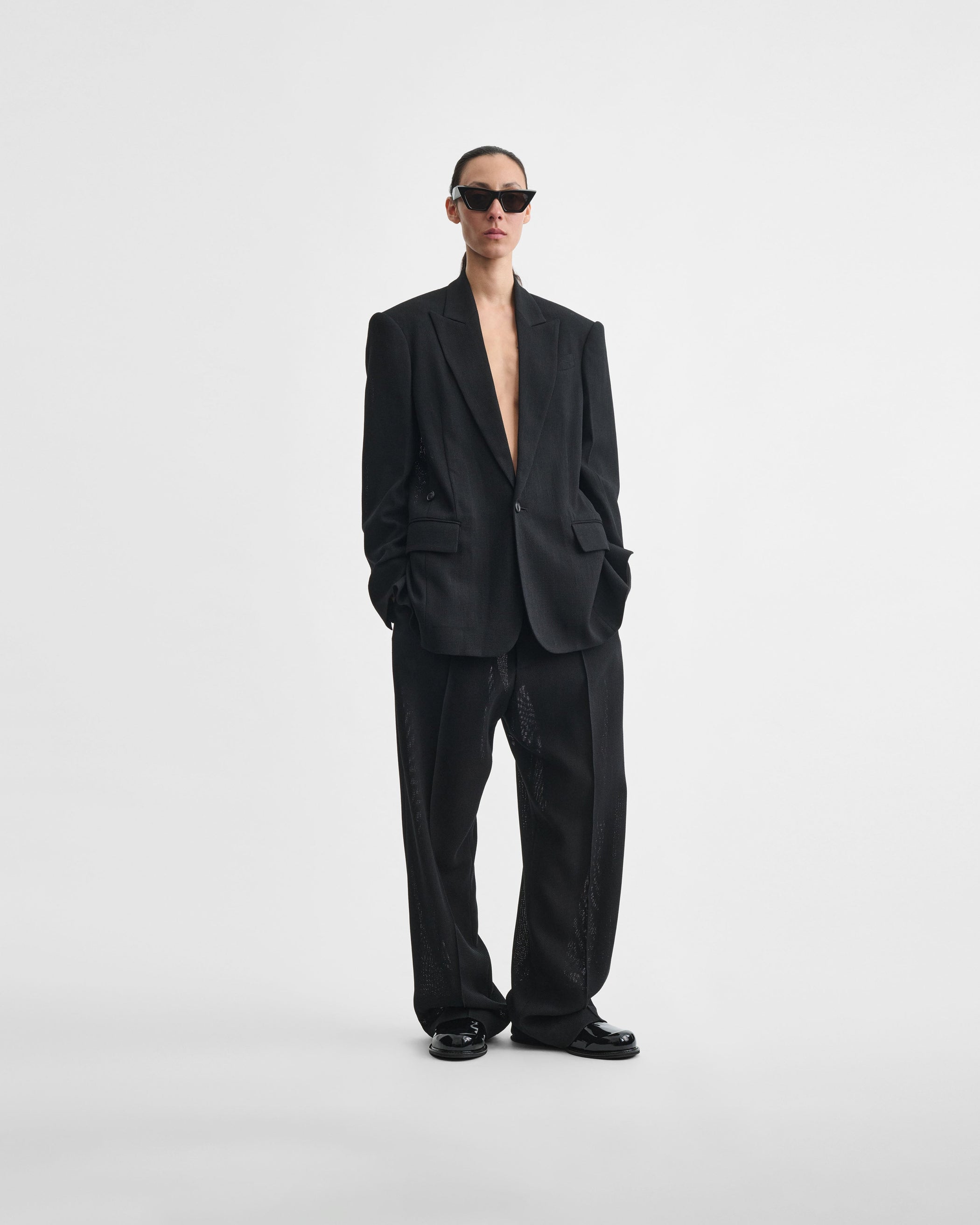 Front view of model wearing CINCHED TAILORED JACKET in black woven viscose
