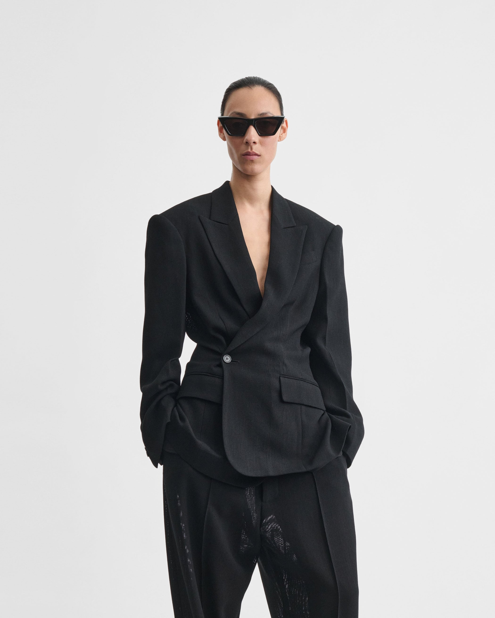 Closer front view of model wearing CINCHED TAILORED JACKET in black woven viscose
