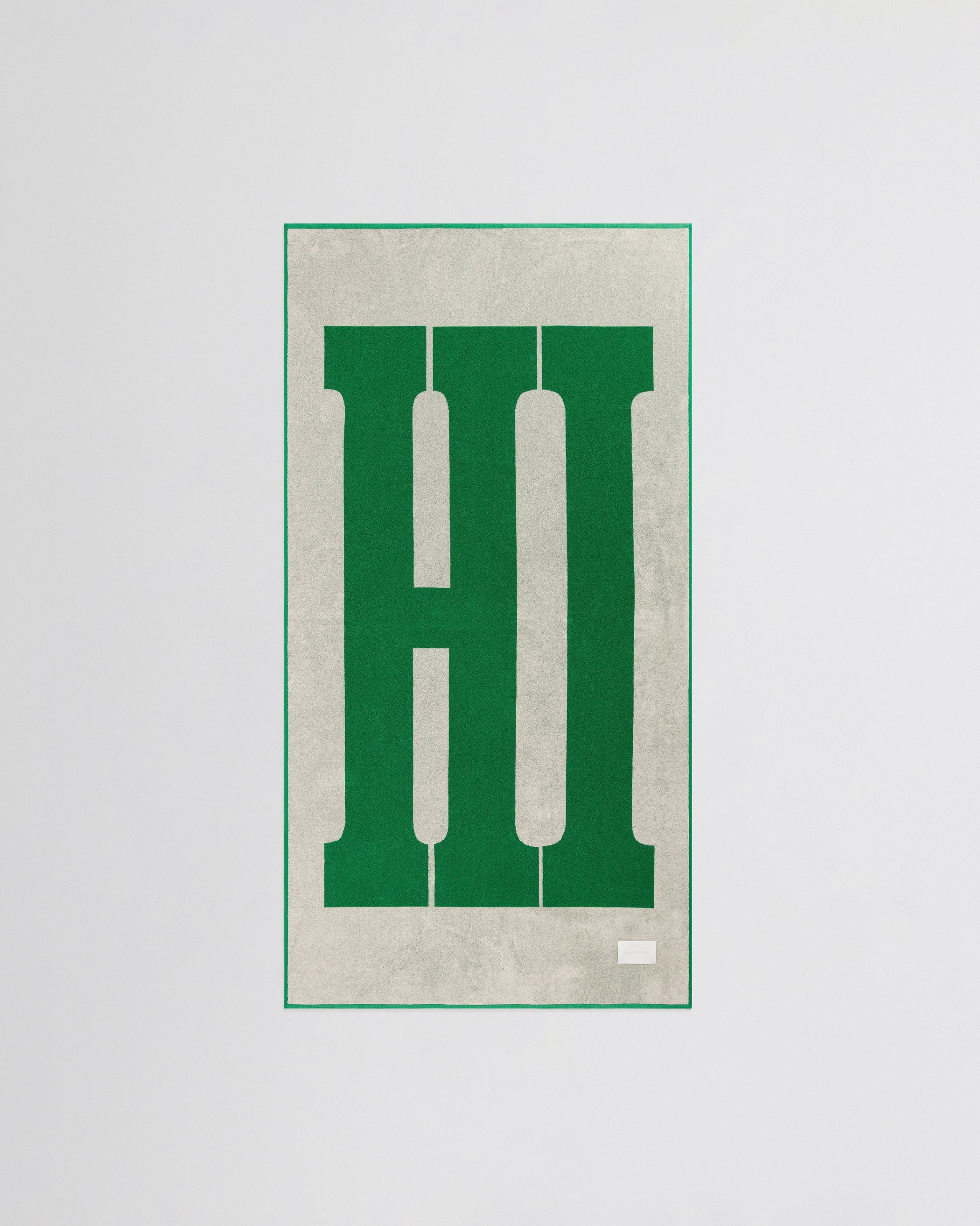 Flat back view of HI TOWEL in electric green cotton