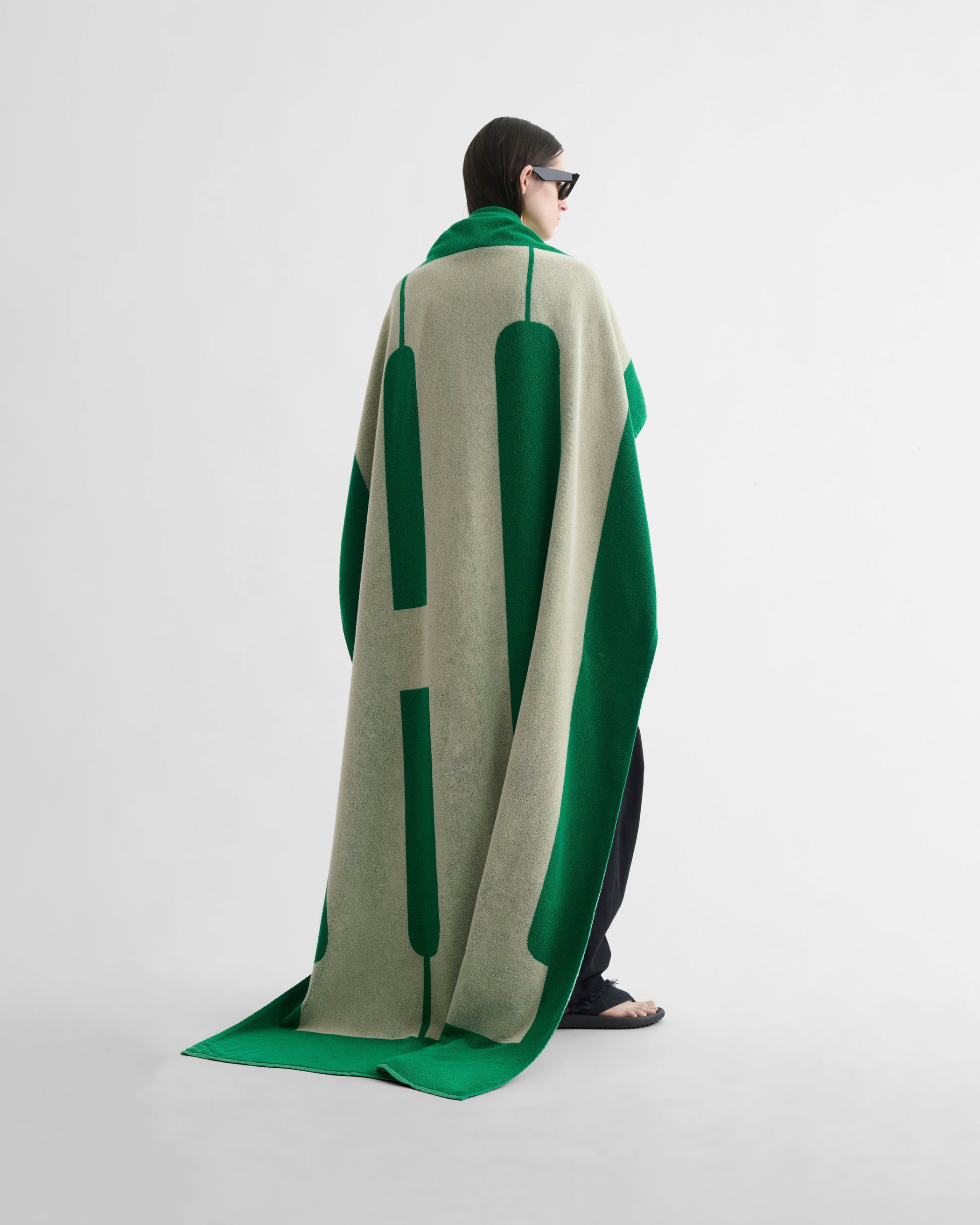 Back view of model wearing HI TOWEL in electric green cotton