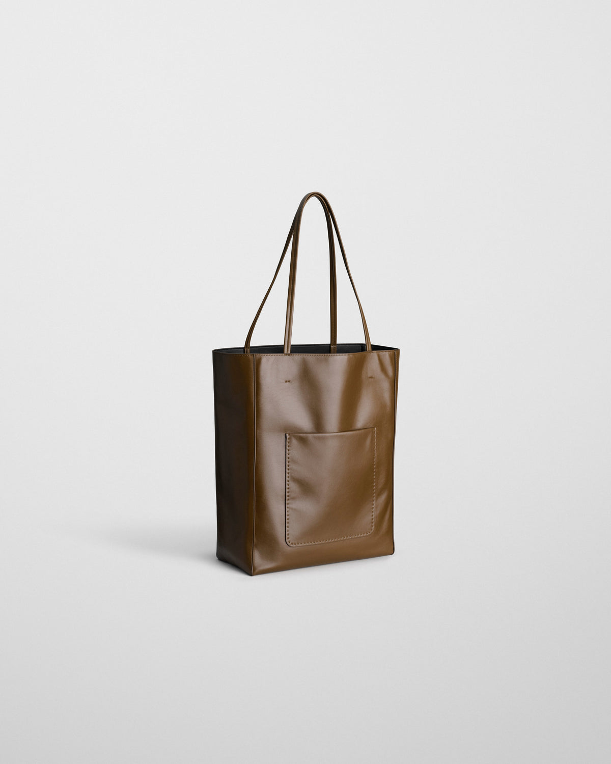 Angled front view of PAPER TOTE in olive leather