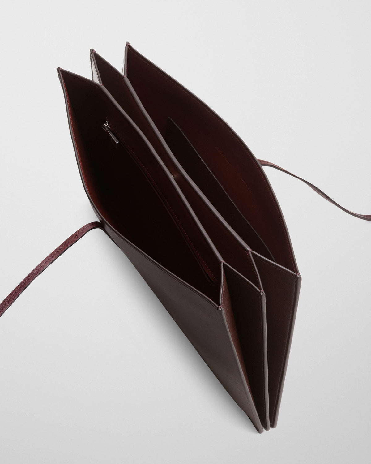 Detail view of SPLAY CLUTCH in bitter chocolate leather