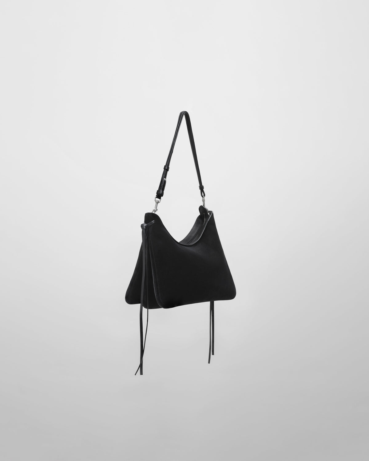 Angled front view of GIG BAG in black suede