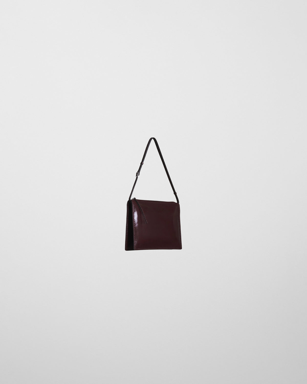 Angled front view of GLOVE POCHETTE in oxblood leather